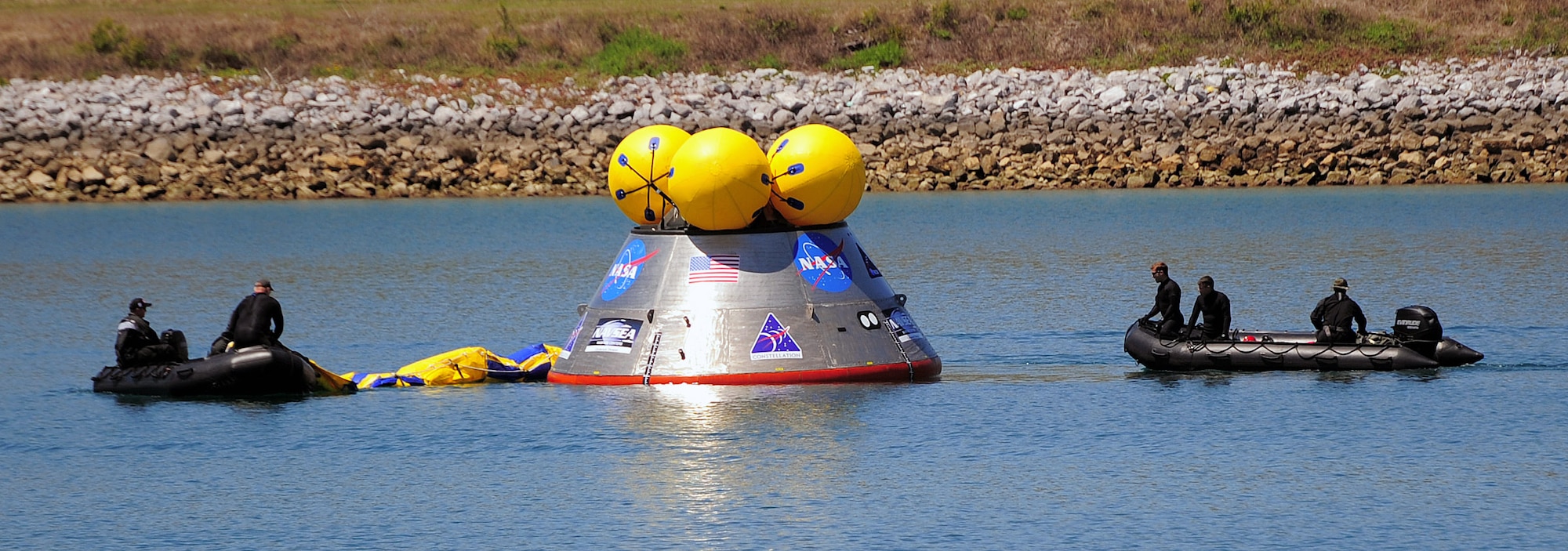 Pararescuemen deploy an inflatable flotation collar during recovery testing on a mockup of the Orion crew exploration vehicle March 8 at the Trident Basin at Port Canaveral, Fla. The collar is designed both to stabilize the capsule after water landing and provide a platform for recovery personnel to stand on during the operation. Reservists from the Reserve's 920th Rescue Wing provide contingency medical and recovery support for all NASA shuttle launches. (U.S. Air Force photo/Tech. Sgt. Paul Flipse) 
