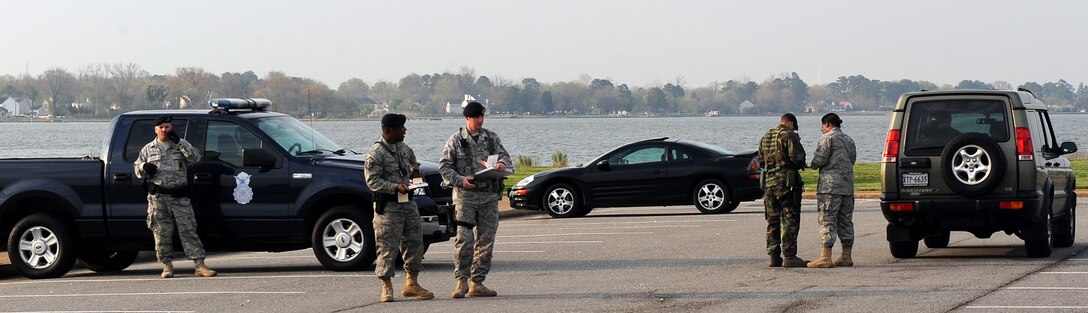 LANGELY AIR FORCE BASE, Va. -- 1st Security Forces Squadron personnel  administers speeding tickets at Memorial Park April 10.  This was part of an operation to enforce the 25 mph speed limit on Nealy Avenue near the dental clinic and the hospital.  (U.S. Air Force photo/Airman 1st Class Zachary Wolf) 