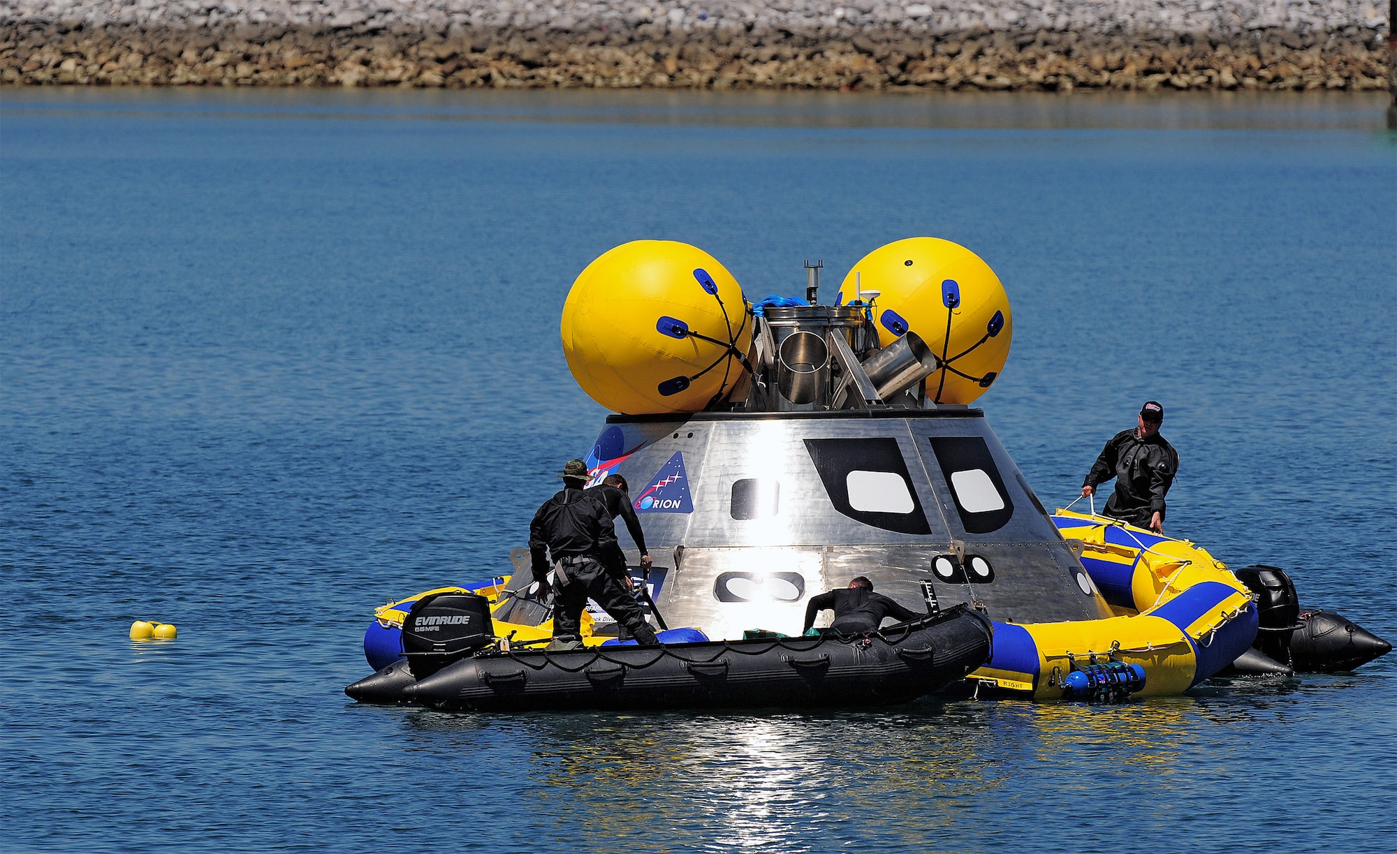 Pararescuemen deploy an inflatable flotation collar during recovery testing on a mockup of the Orion crew exploration vehicle March 8 at the Trident Basin at Port Canaveral, Fla. The collar is designed both to stabilize the capsule after water landing and provide a platform for recovery personnel to stand on during the operation. Reservists from the Reserve's 920th Rescue Wing provide contingency medical and recovery support for all NASA shuttle launches. (U.S. Air Force photo/Tech. Sgt. Paul Flipse) 
