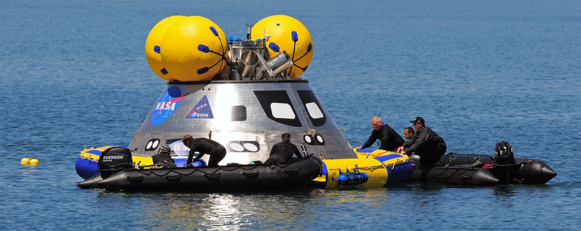 Pararescuemen deploy an inflatable flotation collar during recovery testing on a mockup of the Orion crew exploration vehicle March 8 at the Trident Basin at Port Canaveral, Fla. The collar is designed both to stabilize the capsule after water landing and provide a platform for recovery personnel to stand on during the operation. Reservists from the Reserve's 920th Rescue Wing provide contingency medical and recovery support for all NASA shuttle launches. (U.S. Air Force photo/Tech. Sgt. Paul Flipse) 