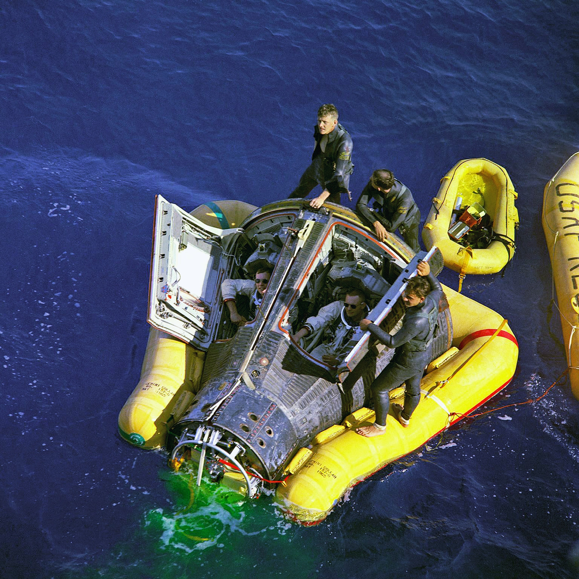 Air Force pararescuemen flank Astronauts Neil A. Armstrong and David R. Scott, sitting in the Gemini 8 space craft, while awaiting the arrival of the recovery ship, the USS Leonard F. Mason after splashdown in the Pacific Ocean March 16, 1966, in the Philippine Sea. Reservists from the 920th Rescue Wing at Patrick Air Force Base, Fla., provide first-response contingency medical and rescue support for all NASA shuttle launches. With the advent of the NASA's new capsule-based, manned-spaceflight program, Constellation, Air Force pararescuemen will once again greet astronauts on the high seas following splashdown. (NASA photo) 