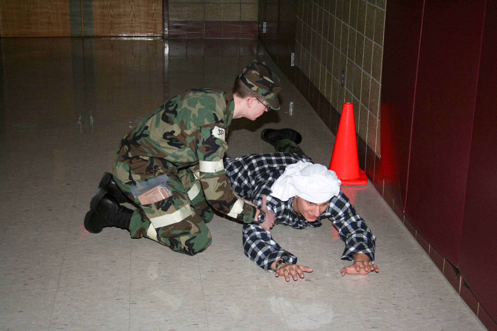 Cadet 4th Class Mark Kubat, AFROTC Detachment 610, restrains an "insurgent"  during a Mock Deployment Exercise on February 28, 2009 at the Grand Forks Army National Guard Base in Grand Forks, North Dakota. The exercise trained 100 cadets about the different aspects of a deployment and how to react to combat situations. (photo by C/3c Kyle Schroeder) (Released) 