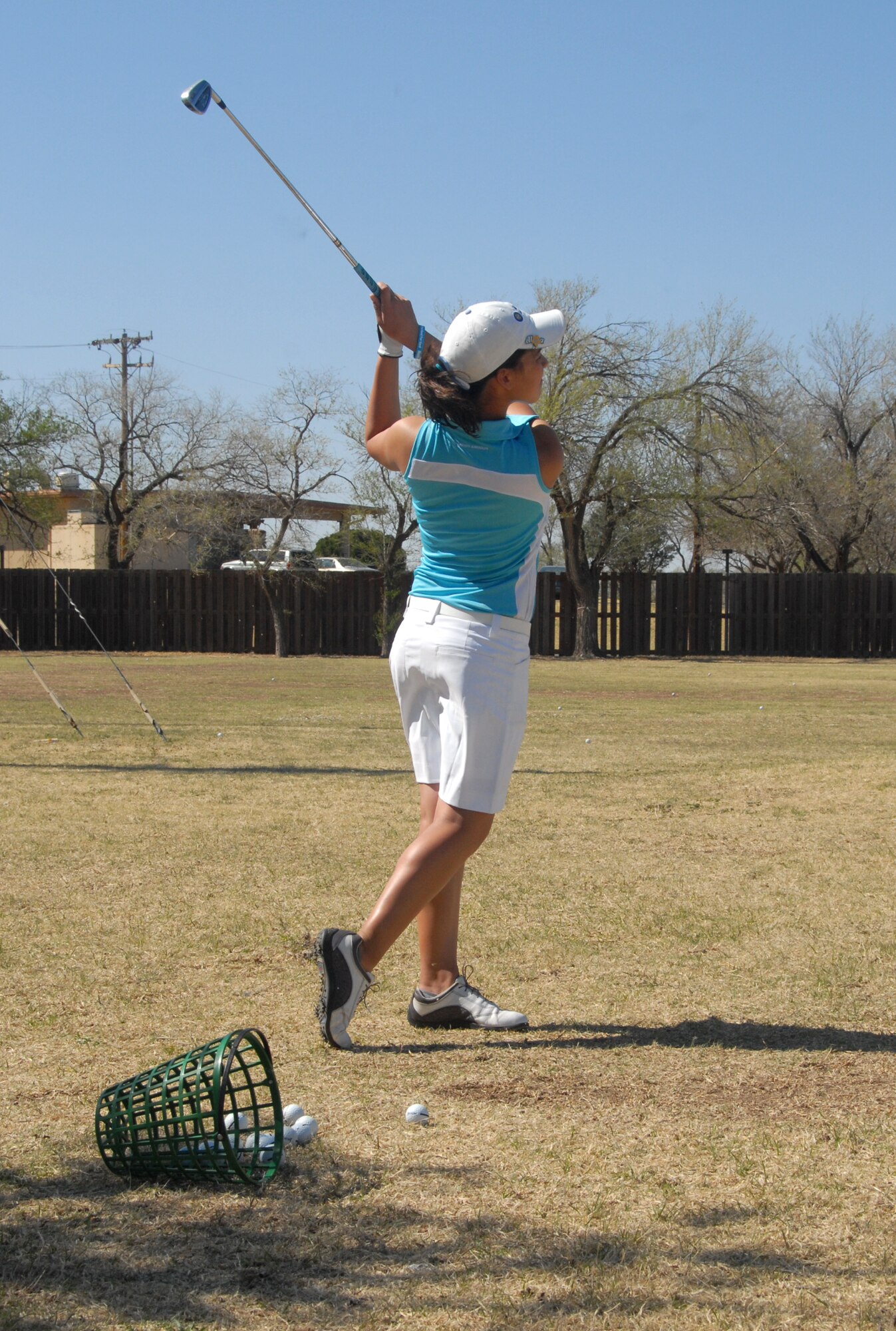 ALTUS AIR FORCE BASE, Okla. -- Megan Blonien, a member of the Altus High School Lady Bulldogs' varsity golf team, perfects her swing at the driving range on Altus Air Force Base April 7. The Lady Bulldogs, currently ranked as the number one 5A team in the state, are training for the regional championship which will be held April 29 at Crimson Creek golf course, El Reno, Okla.  The team practices at the base driving range Monday through Friday. Although the team is composed of only Altus High students, there will be a summer program available for all children, ages 10 through 17. For more information call 580-318-4508.(U.S. Air Force photo/Airman 1st Class Cherice I. Bryant) 
