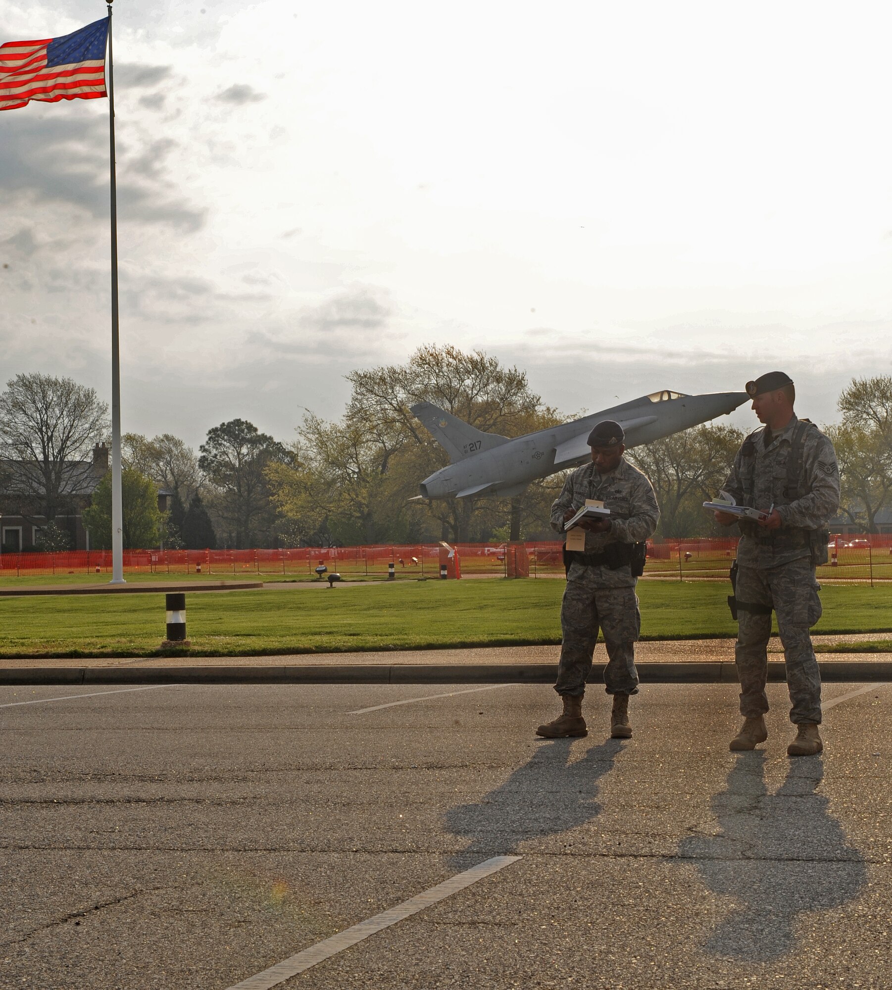 LANGLEY AIR FORCE BASE, Va. -- Master Sgt. Anthony Edwards and Staff Sgt. Brandon Olson, 1st Security Forces Squadron, prepare to write tickets at Memorial Park for individuals caught speeding near the hospital April 10.  This was part of an operation to enforce the 25 mph speed limit on Nealy Avenue near the dental clinic and the hospital.  (U.S. Air Force photo/Airman 1st Class Zachary Wolf)   
