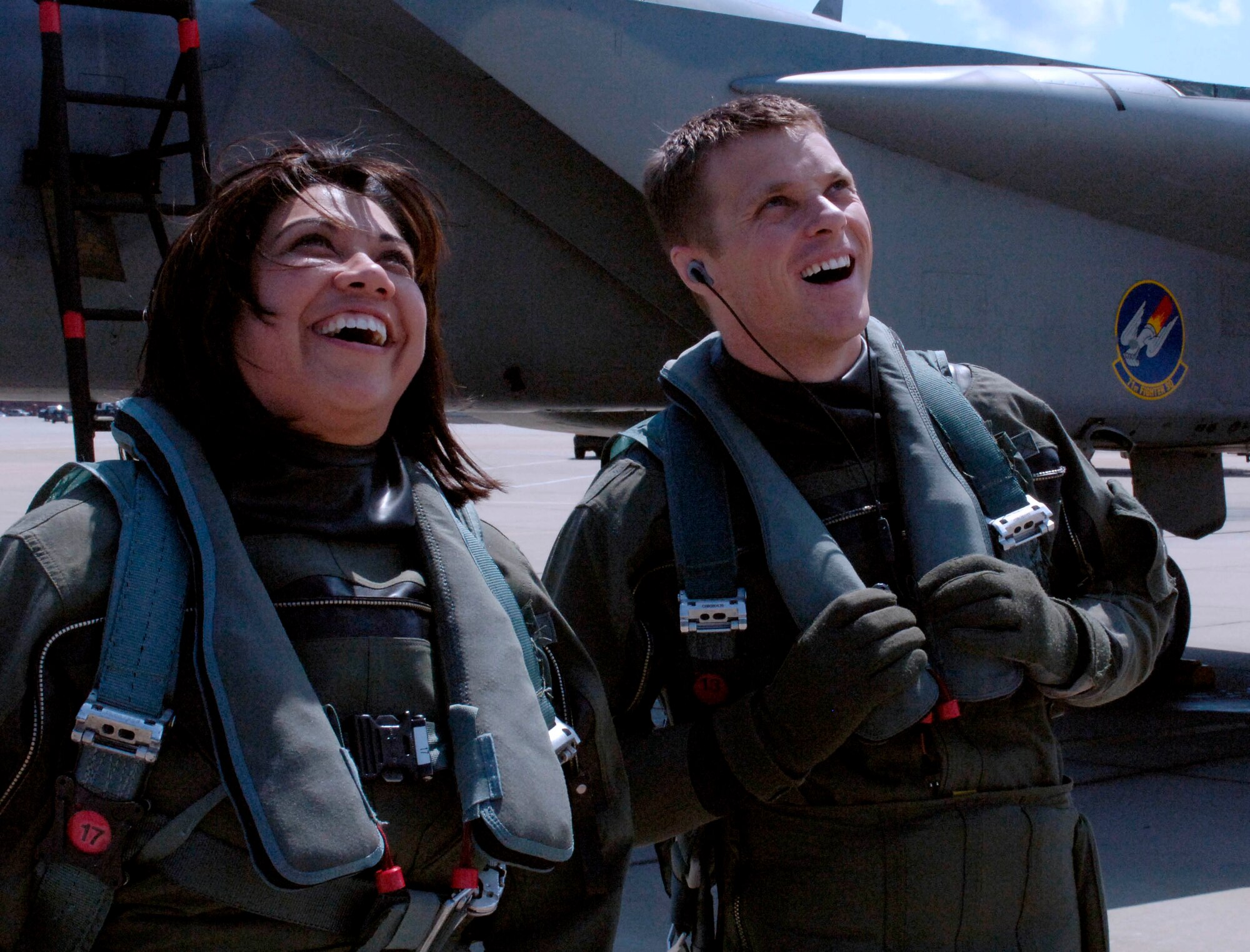 LANGLEY AIR FORCE BASE, Va.-- Bianca Martinez, WTKR Channel 3 broadcaster, and 1st Lt. Glenn Meleen, 71st Fighter Squadron pilot, watch an F-22 Raptor demonstration April 9. Mrs. Martinez spent the day as a fighter pilot for her series entitled "Do My Military Job," where she explores different career fields in each branch of service. (U.S. Air Force photo/Airman Rebecca Montez)