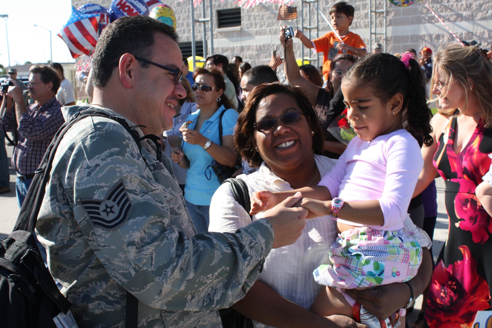HOMESTEAD AIR RESERVE BASE, Fla. – Tech. Sgt. Wilfredo Aguila, 482nd Aircraft Maintenance Squadron, is greeted after returning home after a deployment to Joint Base Balad, Iraq, on April 9. The 67 returning pilots and maintenance crews generated hundreds of close air support and surveillance and reconnaissance missions in support of U.S., Iraqi and Coalition ground forces working to stabilize the country. Thursday’s homecoming is part of a larger deployment package of almost 400 reservists who have rotated in and out of two locations in Iraq. The 482nd Fighter Wing’s current mission in Iraq is drawing to a close as over 100 Homestead reservists will return home in May and June. (U.S. Air Force photo)