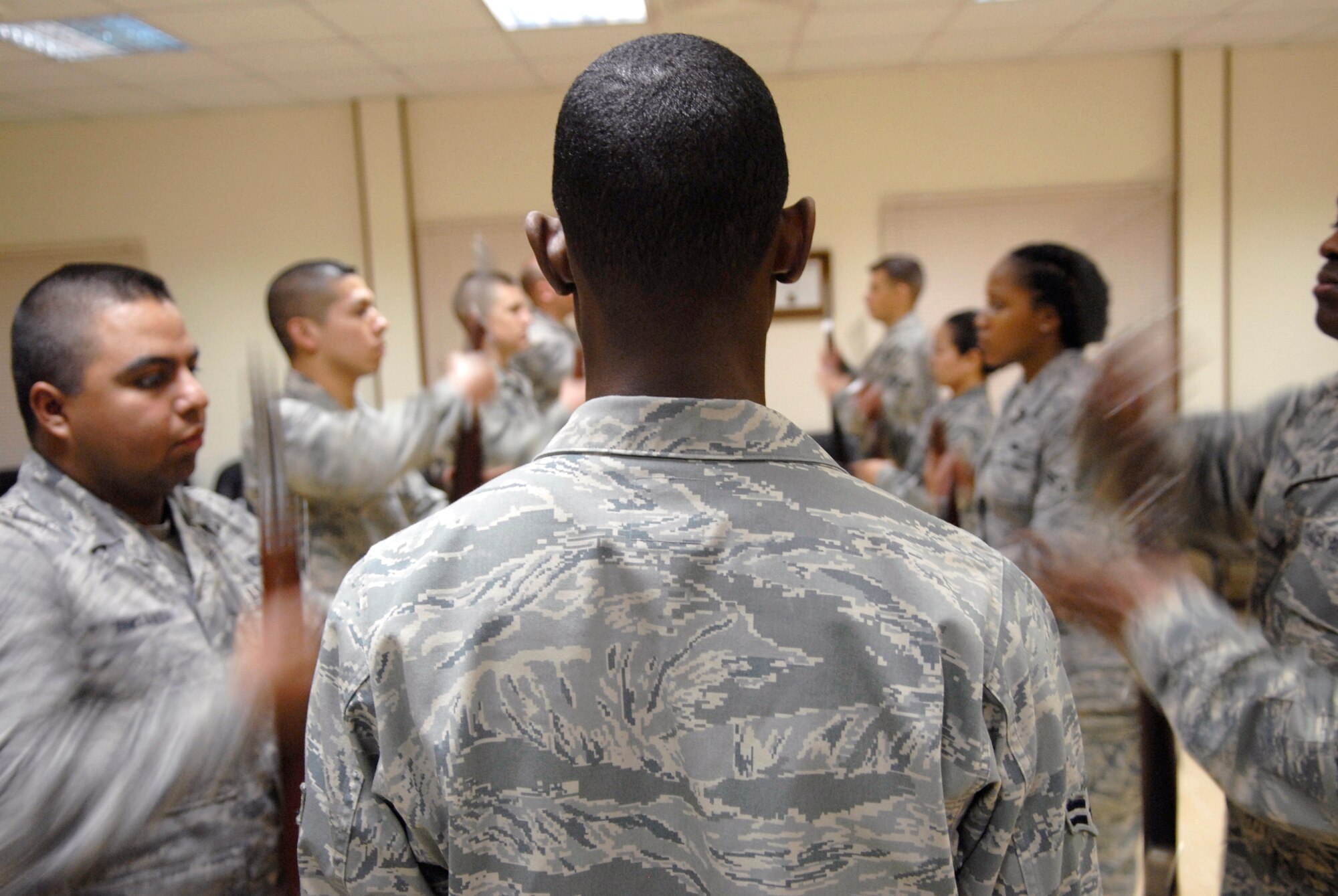 Airman 1st Class Clifford Daniel, from 379th Expeditionary Civil Engineer Squadron, instructs Airmen volunteering in the base Honor Guard during a drill practice with rifles, Apr. 7, 2009, at an undisclosed location in Southwest Asia.  The base Honor Guard has 20 members who help instruct and perform ceremonial duties to include; change of commands, graduations, POW/MIA ceremonies, and posting of the colors.  Airman Daniel hails from Louisville, Ky. and is deployed from Scott Air Force Base, Ill. in support of Operations Iraqi and Enduring Freedom and Combined Joint Task Force - Horn of Africa.  (U.S. Air Force photo/Senior Airman Andrew Satran/released)