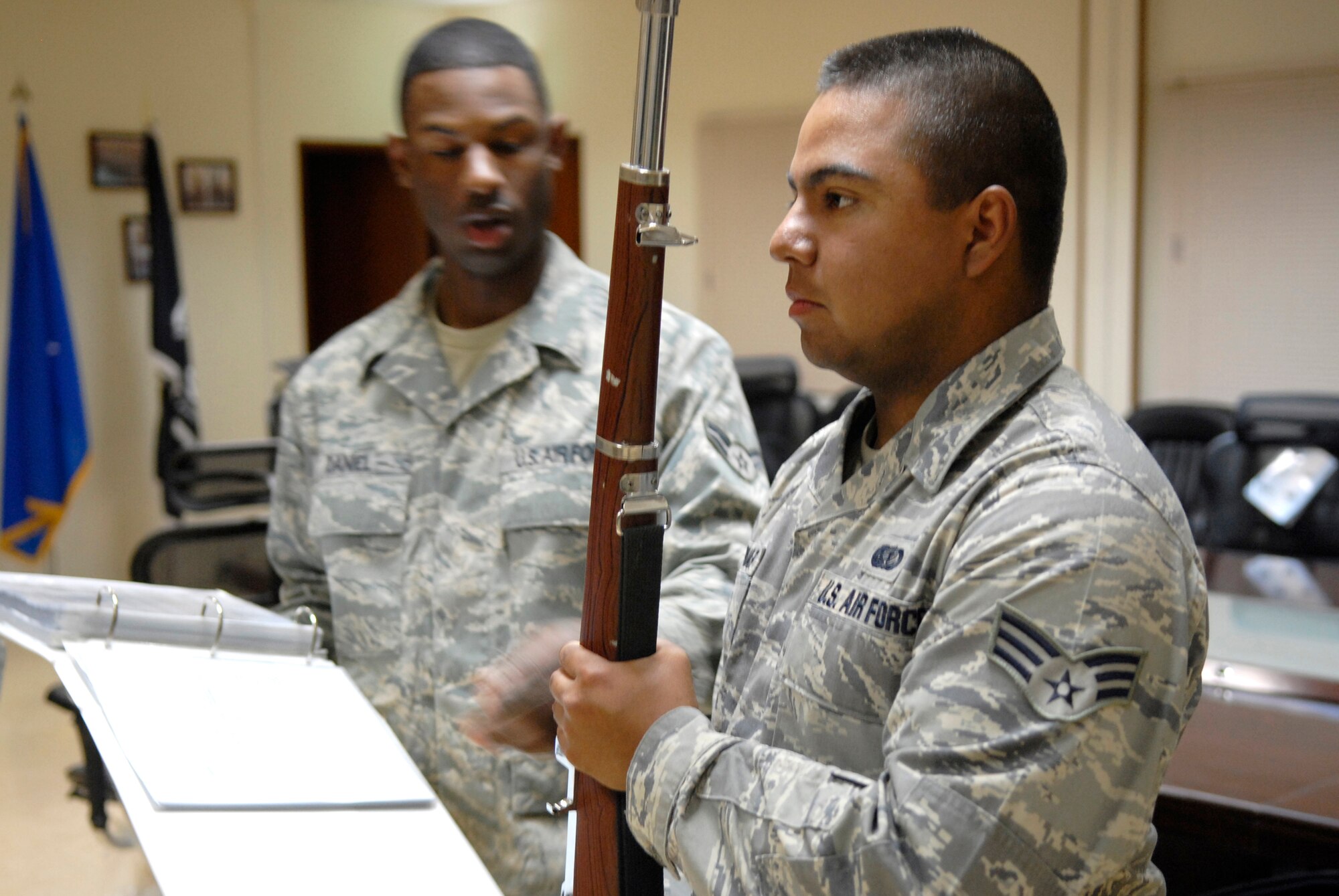Airman 1st Class Clifford Daniels and Senior Airman Ricardo Quintanar, 379th Expeditionary Force Support Squadron Honor Guard instructors, show members of the Honor Guard team correct positioning during a rifle drill, Apr. 7, 2009, at an undisclosed base in Southwest Asia.  Airman Daniel hails from Louisville, Ky. and is deployed from Scott Air Force Base, Ill. with the 379th Expeditionary Civil Engineer Squadron.  Airman Quintanar hails from Austin, Texas and is deployed from Dyess Air Force Base, Texas and is here with the 379th Expeditionary Force Support Squadron.  Both are here in support of Operations Iraqi and Enduring Freedom and Combined Joint Task Force - Horn of Africa.  (U.S. Air Force photo/Senior Airman Andrew Satran/released) 