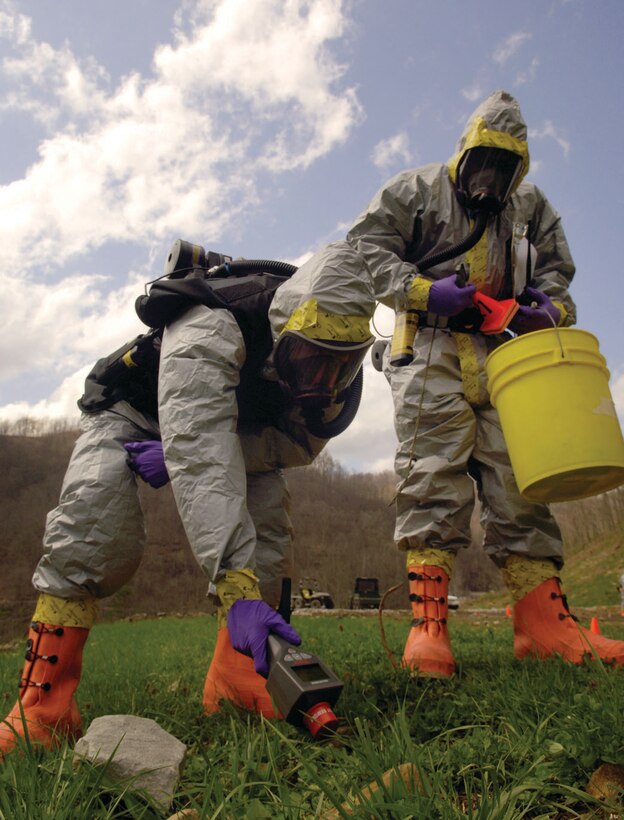Senior Airman Mark Hill and Staff Sgt. Laron Blackshear, members of the Air Force District of Washington CBRNE response force, perform a radiological survey to determine radiation levels around a simulated vehicle-borne radiation dispersal devise explosion scene April 1, 2009. This scenario allowed the team to detect how strong the radiation was, what type, and how far away personnel needed to be in order to be safe. (U.S. Air Force photo/ Senior Airman Renae Kleckner)