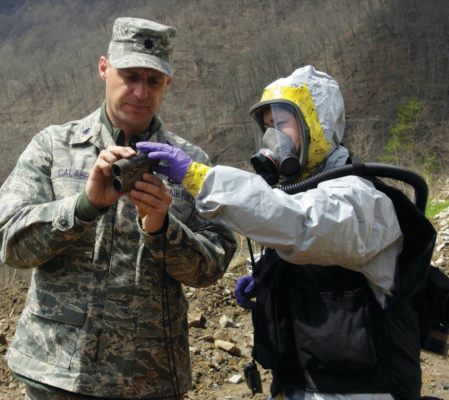 Staff Sgt. Jean Archambeau teaches Lt Col. Lawrenece Calabro, members of the Air Force District of Washington CBRNE response force, how to use a range finder to determine their distance and position from the incident April 1. The center was created after 9/11 to train America's response force how to handle emergency situations through realistic and extensive training. (U.S. Air Force photo/ Senior Airman Renae Kleckner)
