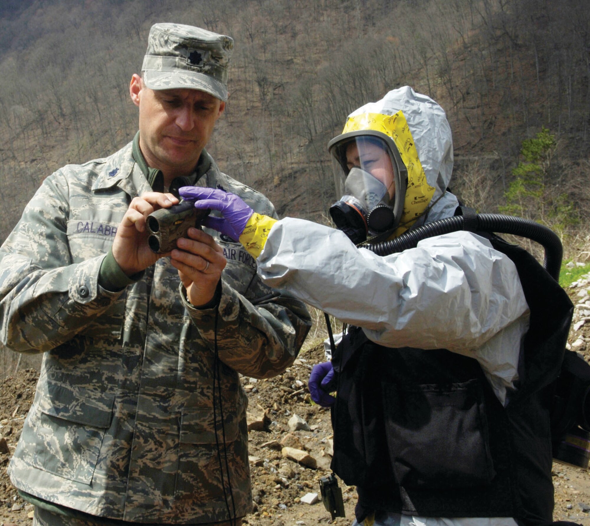 Staff Sgt. Jean Archambeau teaches Lt Col. Lawrenece Calabro, members of the Air Force District of Washington CBRNE response force, how to use a range finder to determine their distance and position from the incident April 1. The center was created after 9/11 to train America's response force how to handle emergency situations through realistic and extensive training. (U.S. Air Force photo/ Senior Airman Renae Kleckner)