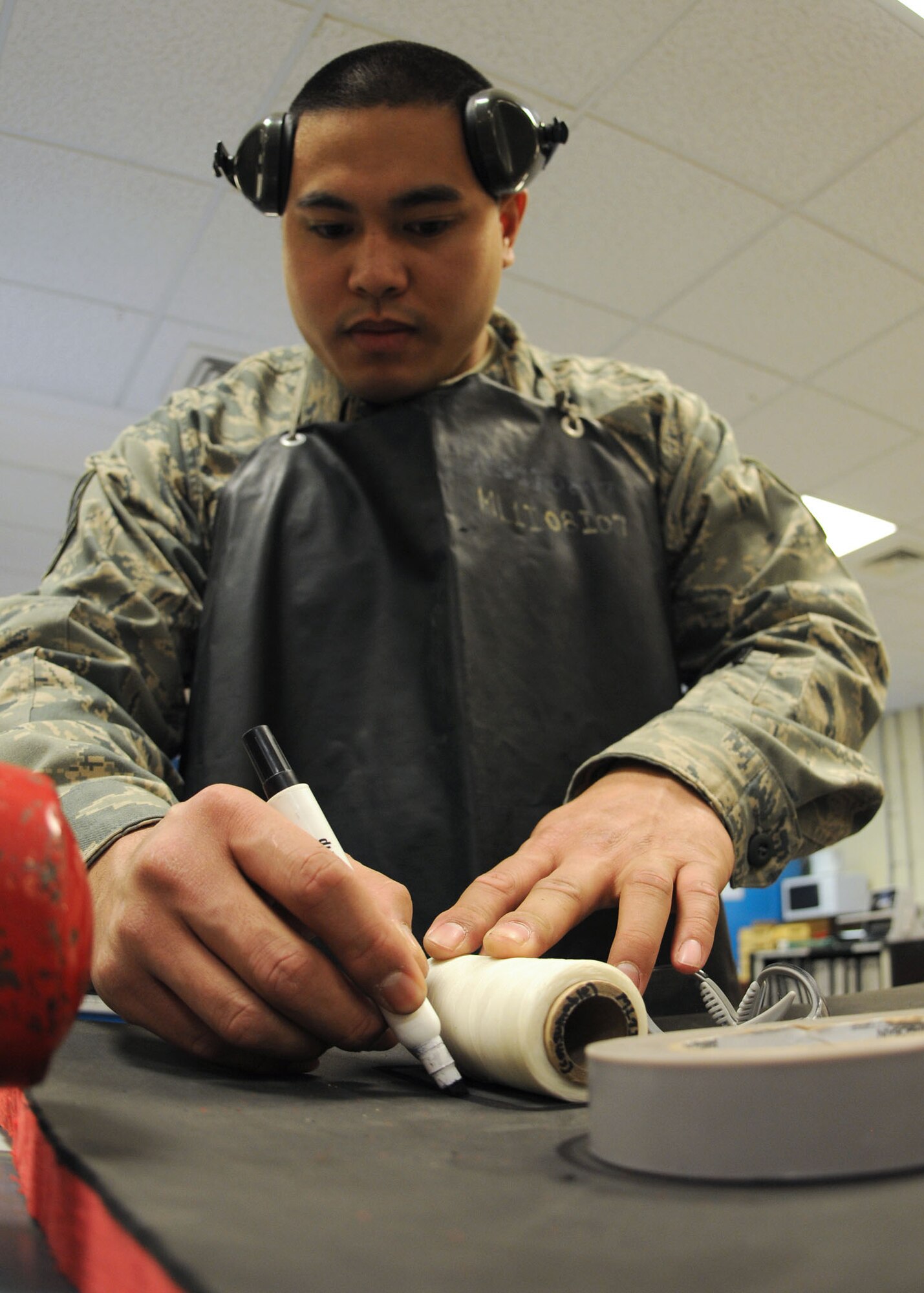 Staff Sgt. Daniel Dela-Cruz, a crew chief from the 100th Maintenance Squadron, traces out items onto a foam board prior to cutting them out April 8 at RAF Mildenhall. With the cutouts, maintainers are able to reduce the time spent looking and accounting for tools and are able to use that time effectively towards mission accomplishment. (U.S. Air Force photo by Staff Sgt. Jerry Fleshman)