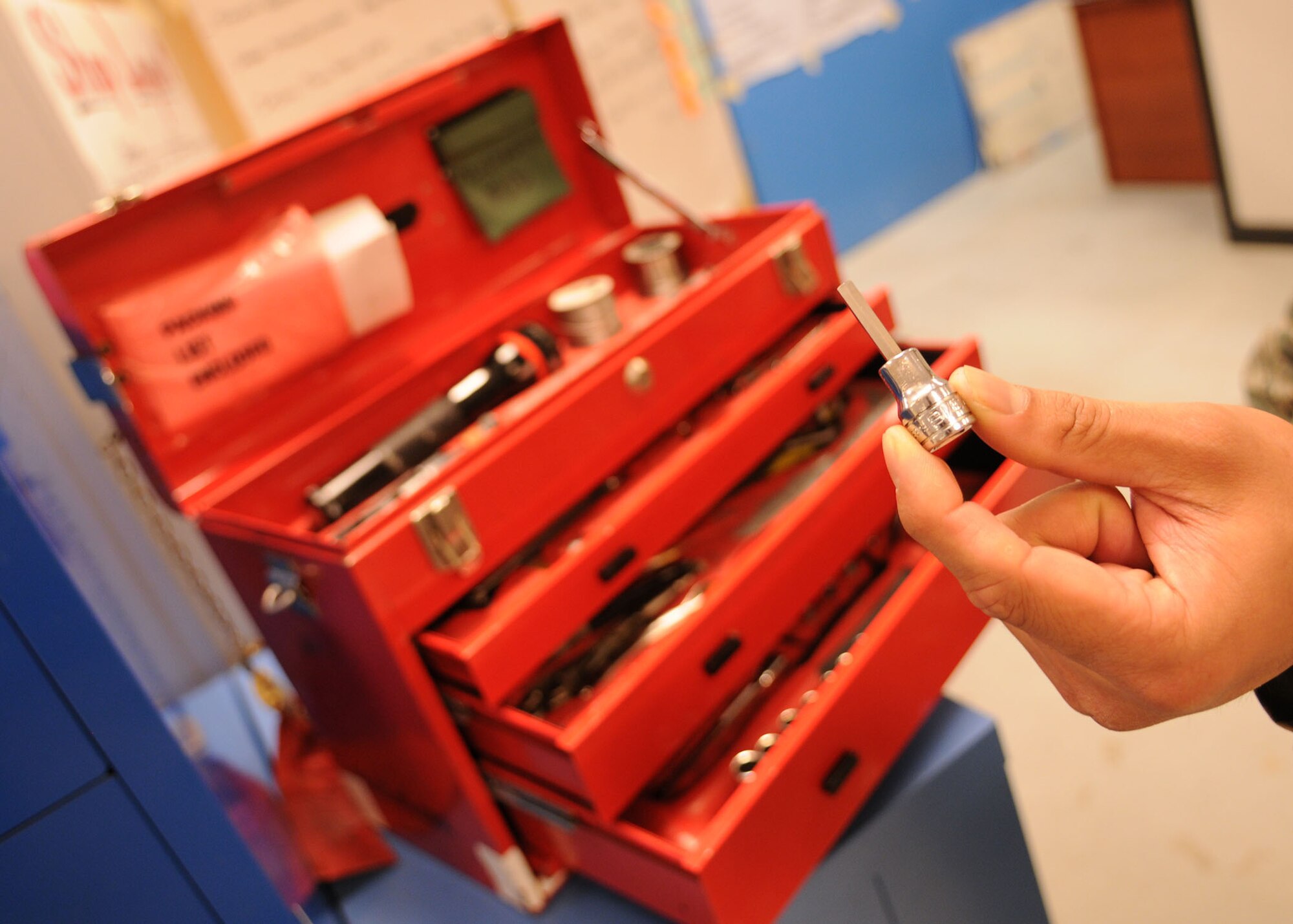 Staff Sgt. Daniel Dela-Cruz, a crew chief from the 100th Maintenance Squadron, displays a hex socket removed from a tool kit as a part of Air Force Smart Operation of the 21st Century program April 8, at RAF Mildenhall. By incorporating AFSO21 into the support section, Sergeant Dela-Cruz was able to reduce the amount of time wasted by removing the hex socket into an individual checkout item. With this and similar changes, Sgt. Dela-Cruz and his team were able to decrease man hours spent inspecting tools by 24% from 790 hours annually to 604. (U.S. Air Force photo by Staff Sgt. Jerry Fleshman)