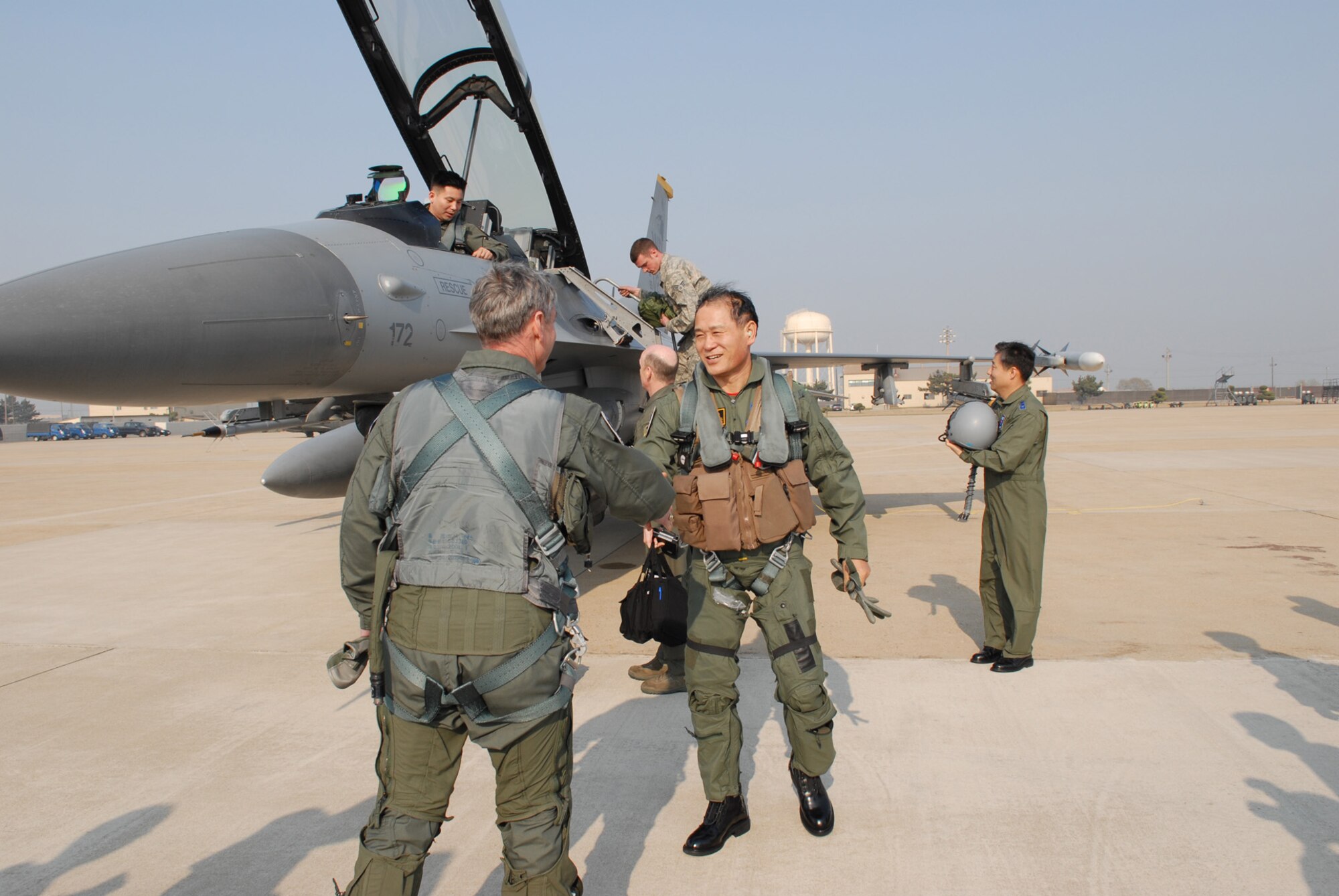 Army Gen. Walter Sharp, United States Forces Korea commander shakes hands with Republic of Korea Army Gen. Lee, Sung Chool, Combined Forces Command deputy commander after their familiarization flight at Kunsan Air Base, Republic of Korea, April 10, 2009. General Sharp was flew with the Republic of Korea Air Force's 38th Fighter Group in order to observe their combat capabilities and interoperability with U.S. forces. General Lee flew with the 8th Fighter Wing's 80th Fighter Squadron. (USAF Photo By: Senior Airman Angela Ruiz)