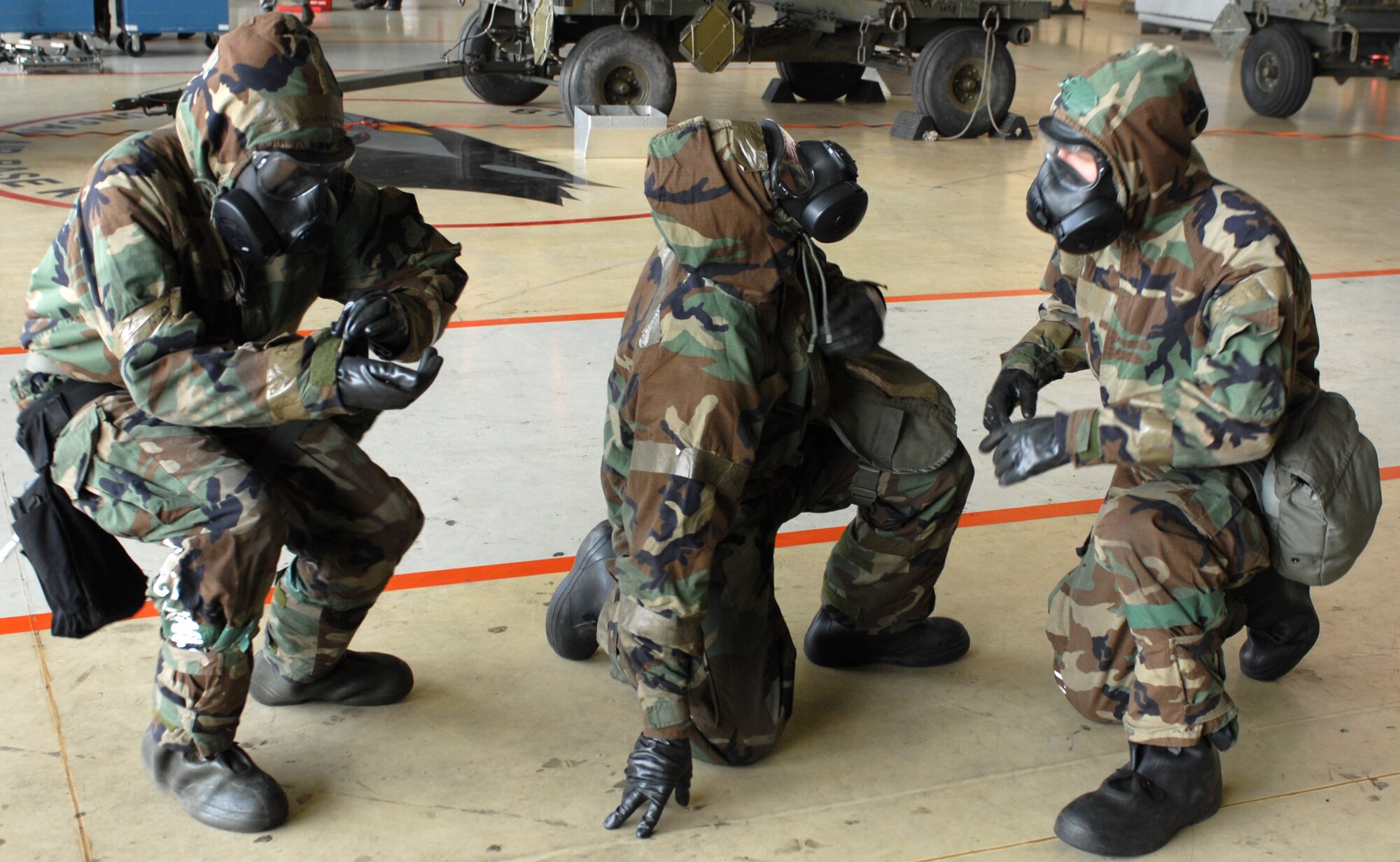 Airmen assigned to the 8th Aircraft Maintenance Squadron complete buddy checks after simulating a missile attack and donning Mission Oriented Protective Posture gear during the monthly Weapons Load Competition at Kunsan Air Base, Republic of Korea, April 10. Airmen participated in load competition while wearing chemical protection gear in preparation for the upcoming Operational Readiness Inspection. (U.S. Air Force Photo/Senior Airman Gustavo Gonzalez)