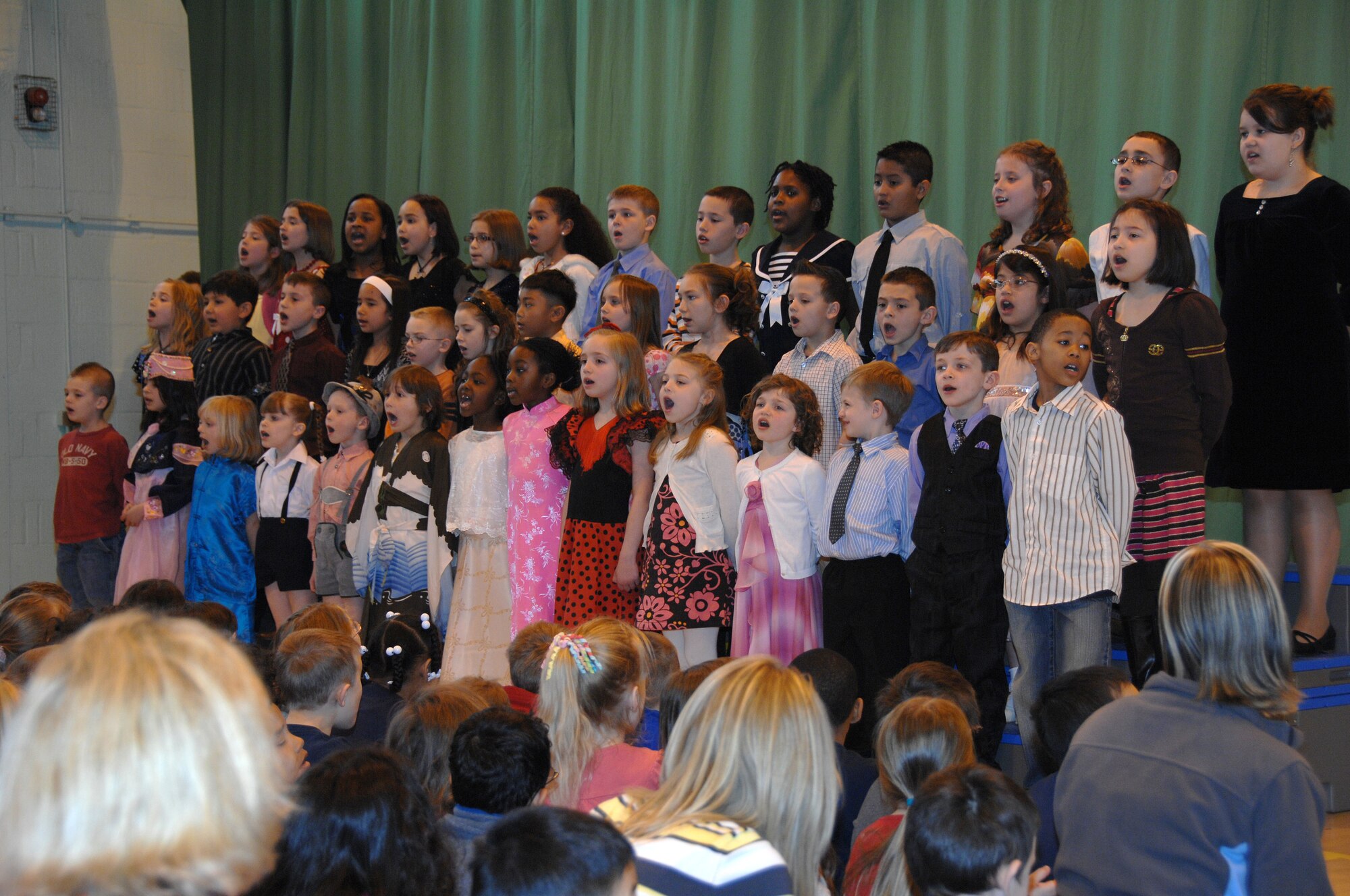 ROYAL AIR FORCE BASE LAKENHEATH--Children from the Lakenheath Elementary School sing God Bless America during a performance in the gymnasium here April 2, 2009. The performance was an event during the month of the military child. Mrs. De De Brown-Johnson, a first grade teacher, wrote and directed "The Heart of a Military Child" play the children recited.(U.S. Photo by Tech. Sgt. Christopher A. Campbell)
