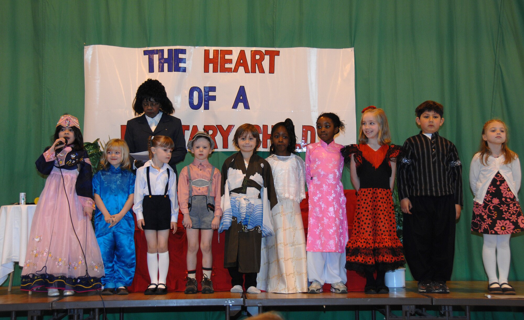 ROYAL AIR FORCE BASE LAKENHEATH--Children from the Lakenheath Elementary School explain what type of American heritage they are proud of during a performance in the gymnasium here April 2, 2009. The performance was an event during the month of the military child. Mrs. De De Brown-Johnson, a first grade teacher, wrote and directed "The Heart of a Military Child" play the children recited. (U.S. Photo by Tech. Sgt. Christopher A. Campbell)