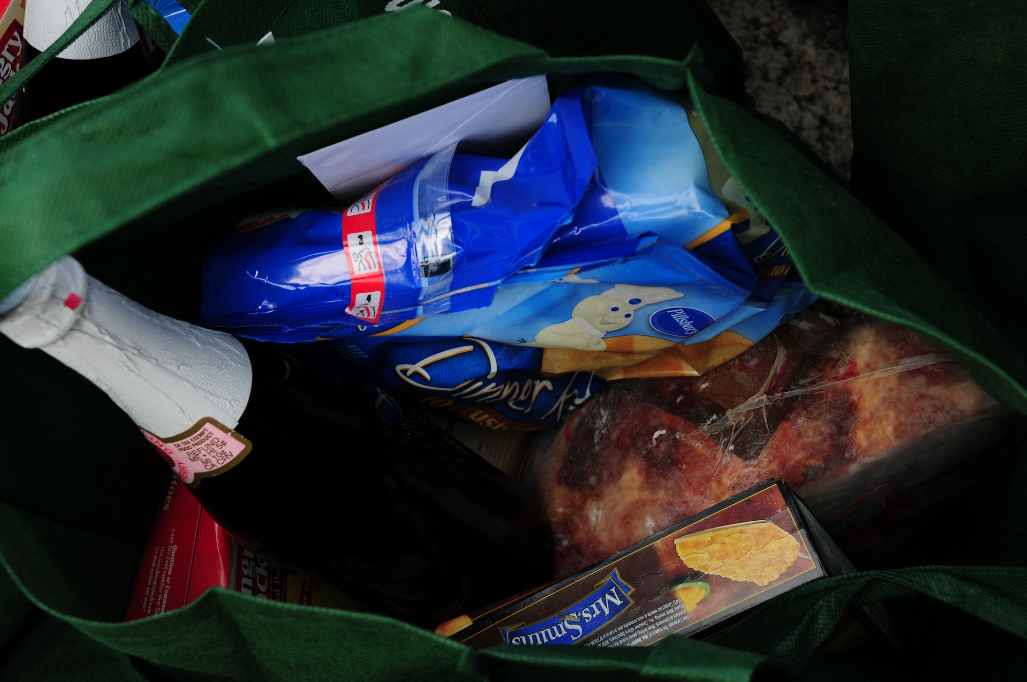 A completed “Spring Basket” filled with a ham, mashed potatoes, gravy, dinner rolls, pie, sparkling cider, and a $25 gift card to AFFES waits to be taken to a family in need on Kadena Air Base April 10, 2009. Operation Warmheart is executed year-round by Kadena’s First Sergeants and receives donations from Kadena Chapels to help fund their programs for families in need. Operation Warmheart also helps families in financial emergencies who don’t qualify for Air Force Aid. (U.S. Air Force official photo/Airman 1st Class Amanda Grabiec)