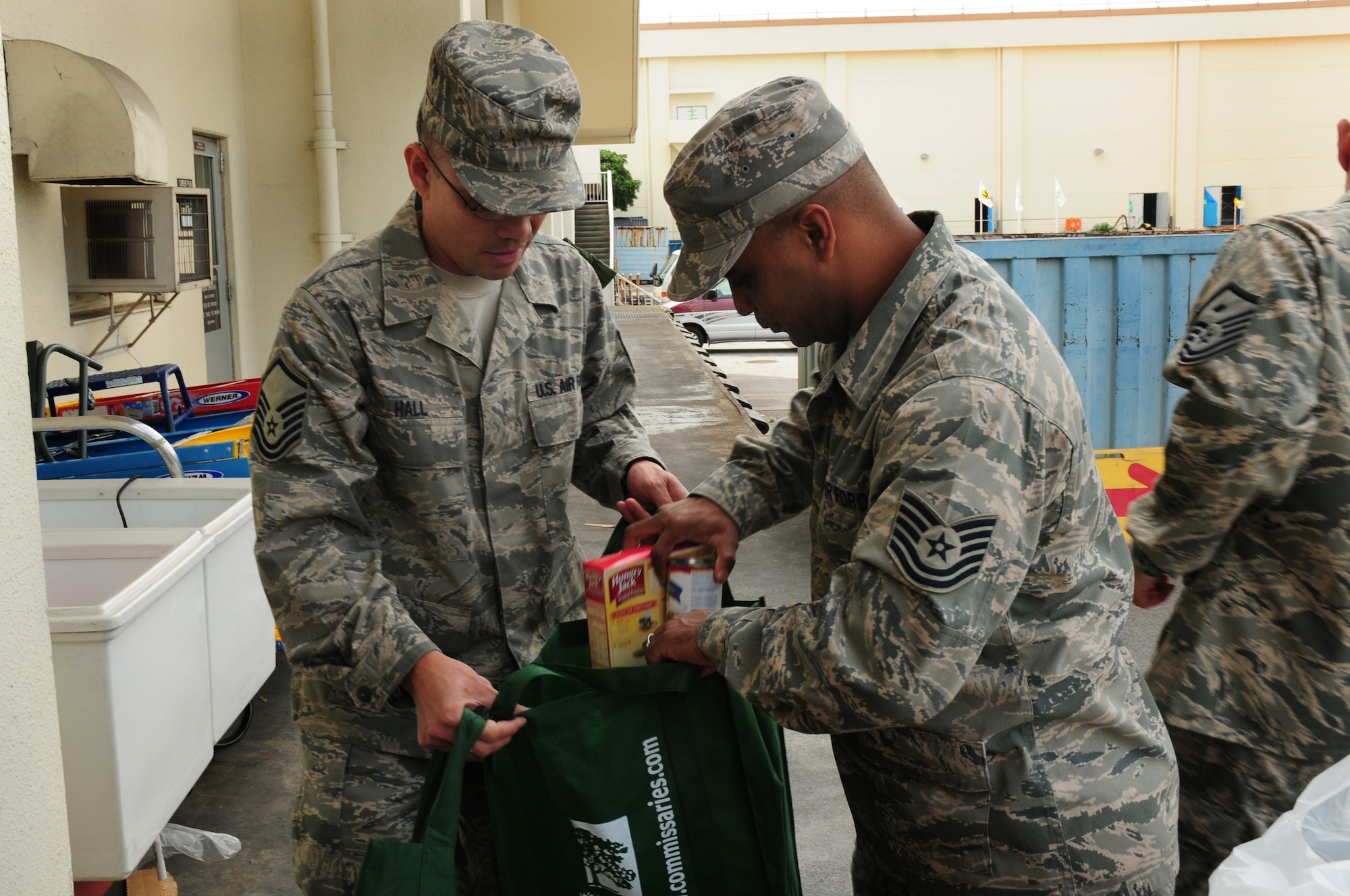 Tech. Sgt. Nelson Pineda, Air Postal Squadron DET3 (right), hands Master Sgt. Rodger Hall, Air Postal Squadron DET3, mashed potatoes and gravy for Operation Warmheart project “Spring Basket” for families in need during the Easter Holiday on Kadena Air Base, April 10, 2009. Operation Warmheart is executed year-round by Kadena’s First Sergeants and receives donations from Kadena Chapels to help fund their programs for families in need. Operation Warmheart also helps families in financial emergencies who don’t qualify for Air Force Aid. (U.S. Air Force official photo/Airman 1st Class Amanda Grabiec)