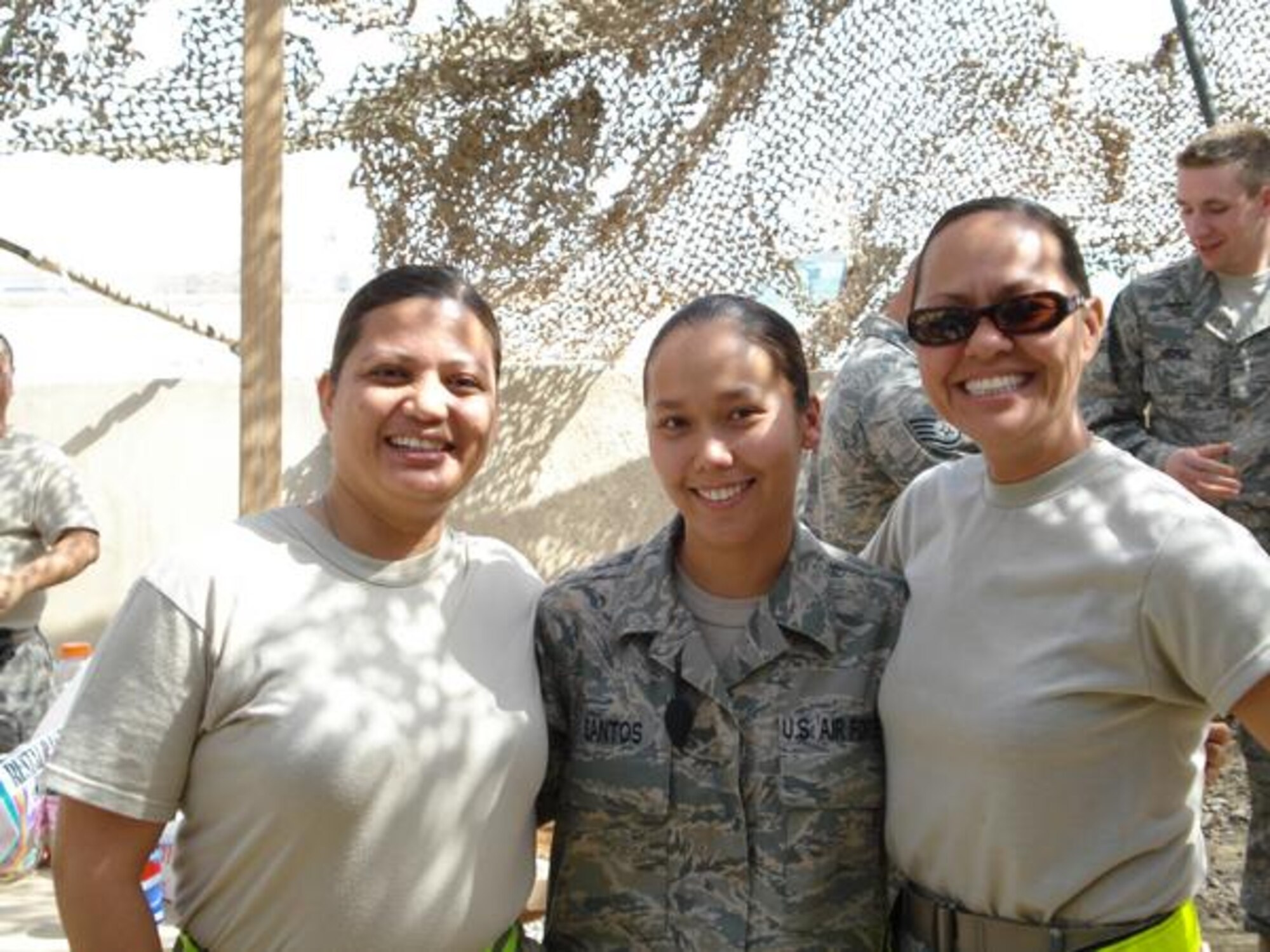 Tech. Sgt. Monica Santos, Senior Airman Khrysallis Santos, and Tech. Sgt. Michelle Quichocho of the 44th Aerial Port Squadron, Andersen Air Force Base, Guam, shown at Sather Air Base in Baghdad, Iraq, in February 2008.  The three friends are single mothers who have volunteered for multiple deployments. (Courtesy photo)