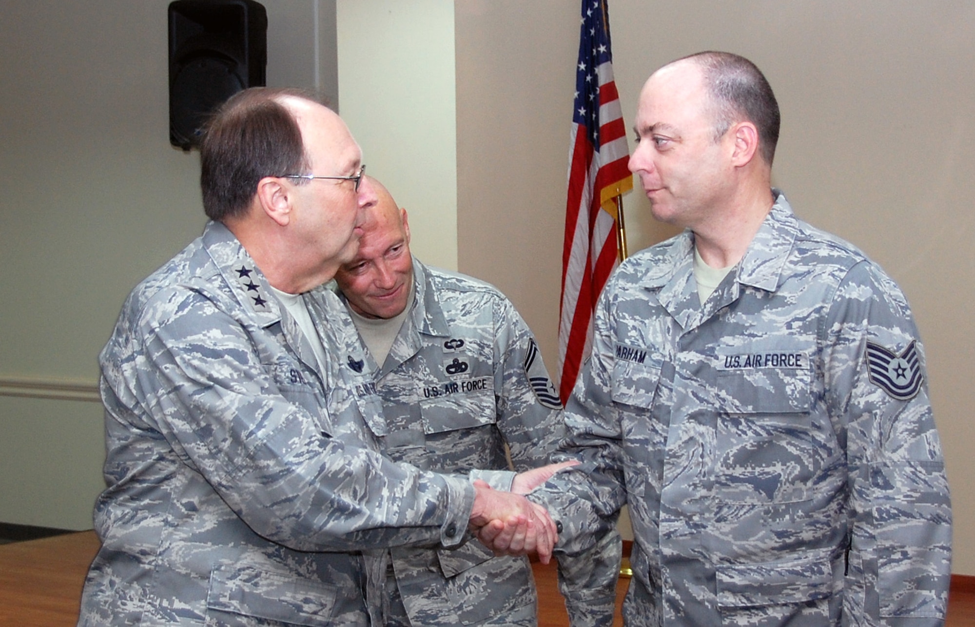 SOUTHWEST ASIA - Lt. Gen. Charles E. Stenner Jr., Air Force Reserve Command commander, coins Tech. Sgt. Jack Parham, 386th Expeditionary Logistics Readiness Squadron Air Terminal Operations Center coordinator, during a commander's call April 9. General Stenner visited the 386th Air Expeditionary Wing as part of a multi-base tour throughout the Air Forces Central Area of Responsibility. (U.S. Air Force photo by Staff Sgt. Thomas J. Doscher)