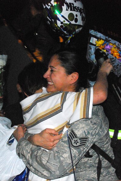 Many family members from the 301st Fighter Wing at Naval Air Station Joint Reserve Base Fort Worth, Texas, enjoy hugs and kisses from those returning from their most recent deployment in support of Operation Iraqi Freedom. More than 40 wing members returned Thursday night with more returning throughout the spring months. (U.S. Air Force Photo/Tech. Sgt. Julie Briden-Garcia)