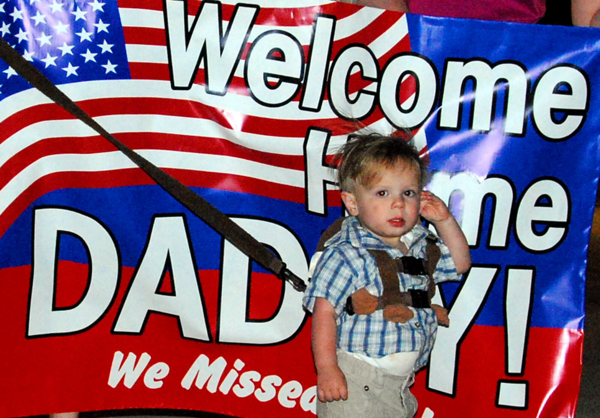 Family members from the 301st Fighter Wing at Naval Air Station Joint Reserve Base Fort Worth, Texas, await the aircraft bringing their spouses, sons and daughters home from Iraq. More than 40 wing members returned Thursday night with more returning throughout the spring months. (U.S. Air Force Photo/Tech. Sgt. Julie Briden-Garcia)