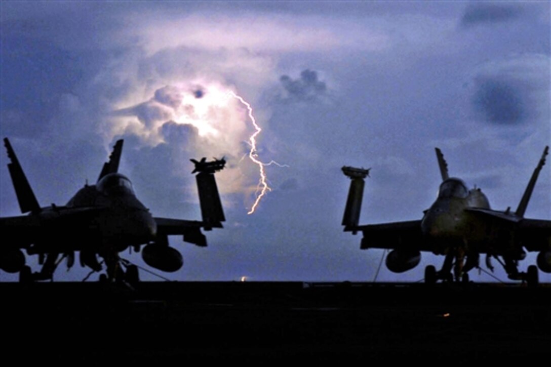 Lightning strikes behind two F/A-18C Hornet strike fighters on the flight deck aboard the aircraft carrier USS John C. Stennis in the Pacific Ocean, April 8, 2009. Stennis is on a scheduled six-month deployment to the western Pacific Ocean.