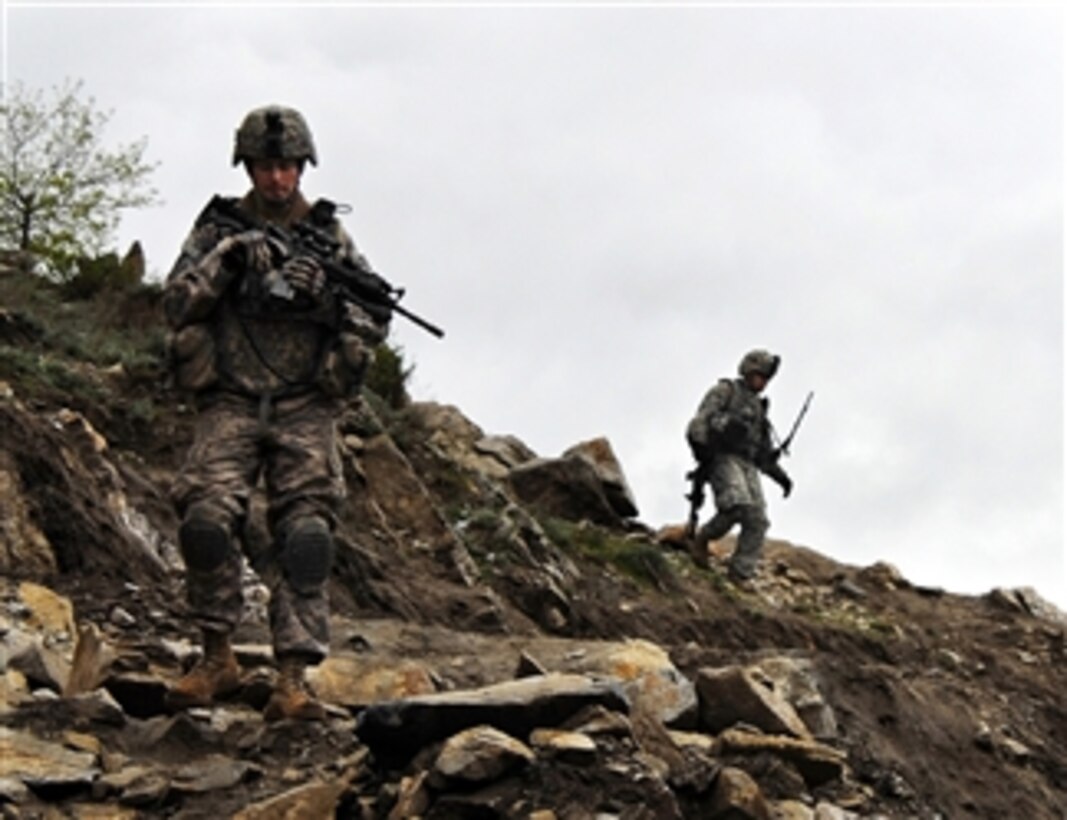 U.S. Army soldiers from Charlie Company, 1st Battalion, 26th Infantry Regiment, 1st Infantry Division patrol cliffs near the village of Walo Tangi Kalay in the Konar province of Afghanistan on April 6, 2009.  