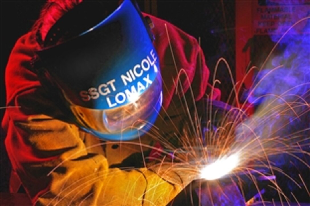U.S. Air Force Staff Sgt. Nicole Lomax uses a metal inert gas welding machine to weld a T-joint for her skill-level upgrade on Lackland Air Force Base, Texas, April 2, 2009. Lomax is assigned to the Air Force Reserve Command's 433rd Airlift Wing.