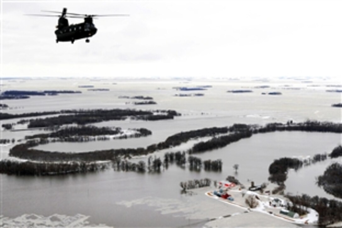 A Montana Army National Guard CH-47D Chinook helicopter flies over the North Dakota-Minnesota border area flooded by the Red River, April 1, 2009. The flight's purpose is to familiarize the aviators and soldiers assigned to the 1st Battalion, 189th Aviation Regiment, to possible flight hazards in the region.