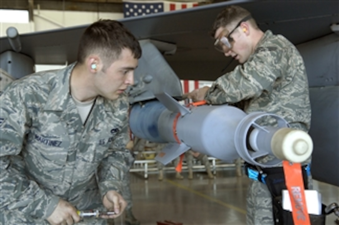 U.S. Air Force Senior Airman James Martinez (left) and Staff Sgt. Mitchell Baker, both members of the 20th Air Maintenance Squadron, participate in the Weapons Load Crew of the Year Competition at Shaw Air Force Base, S.C., on March 20, 2009.  Load crews are evaluated with a written test, toolbox and uniform inspections and a final weapons load demonstration.  