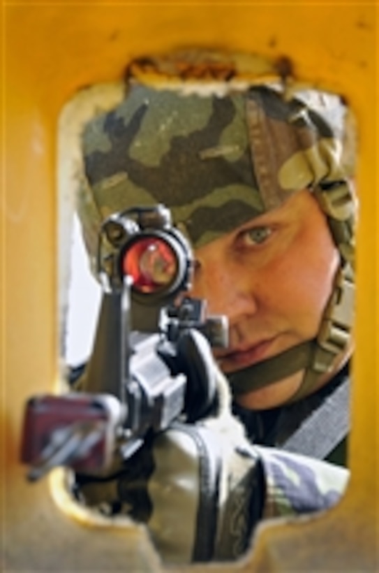 U.S. Air Force Staff Sgt. Norman Heffle from the 48th Security Forces Squadron defends the entry control point from simulated base attackers at Royal Air Force Feltwell, England, on April 2, 2009.  Airmen from the 48th Security Forces Squadron are participating in an air base defense exercise.  The training is an annual requirement for the squadron.  