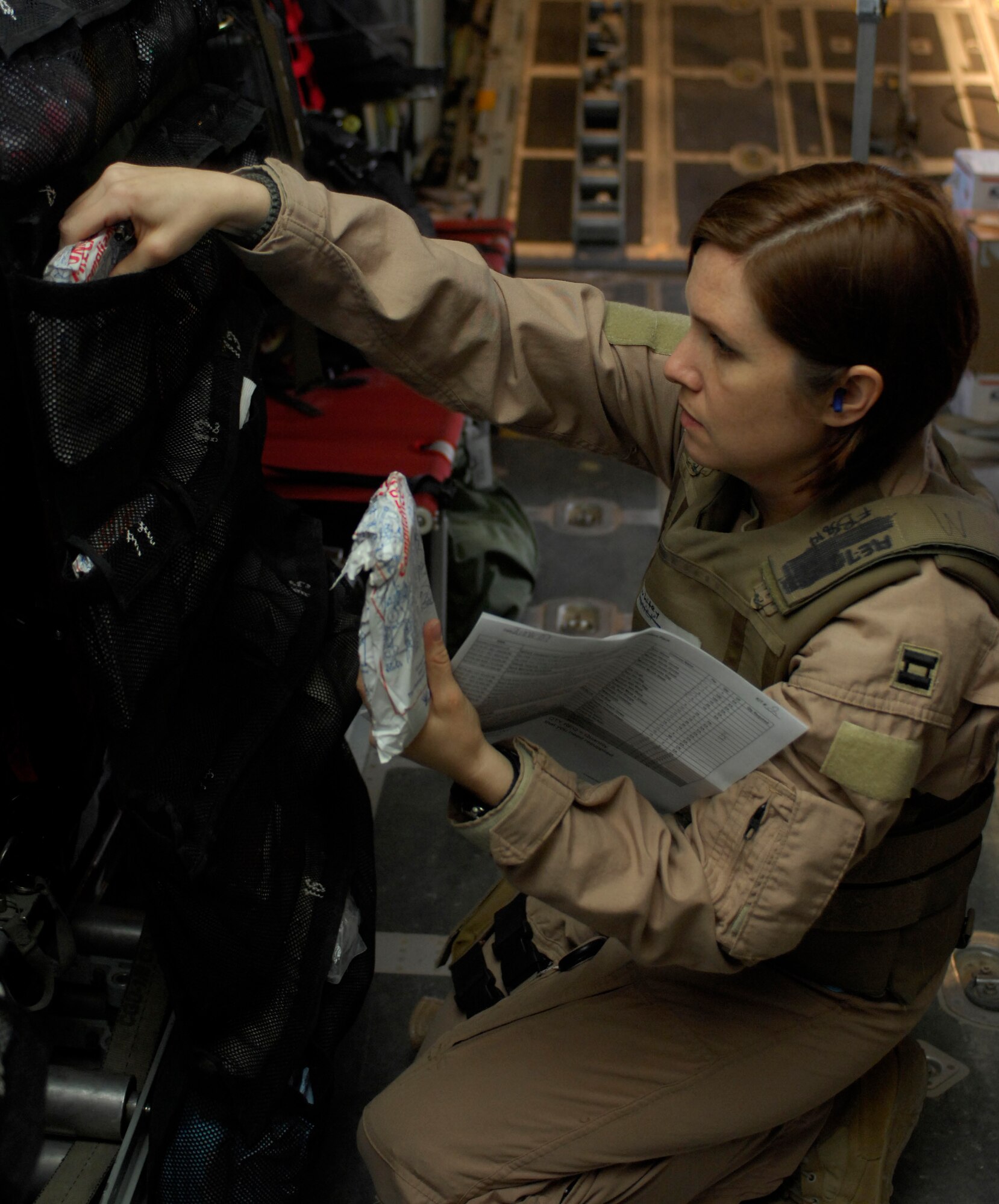 Capt. Susan McCormick, 455th Expeditionary Aeromedical Evacuation Flight, inventories her equipment in flight to Manas Air Base, Krygyzstan, March 26. Captain McCormick prepares for each flight depending on the report given to her by the ground medical team. ?I try to think about the worst, but really we have no idea what the patient will look like when they arrive,? said Captain McCormick. She is deployed from Westover Air Reserve Base, Mass. (U.S. Air Force photo/ Senior Airman Erik Cardenas)(Released)