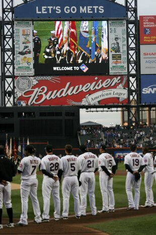 A joint-service color guard marches onto the field as part of the pre-game ceremony for the New York Mets inaugural game at Citi Field, April 13. The Marines unfurled an outfield-sized flag and flew F-18 Hornets overhead to kick-off the season in the new stadium. (Official U.S. Marine Corps Photo by Sgt. Randall A. Clinton)