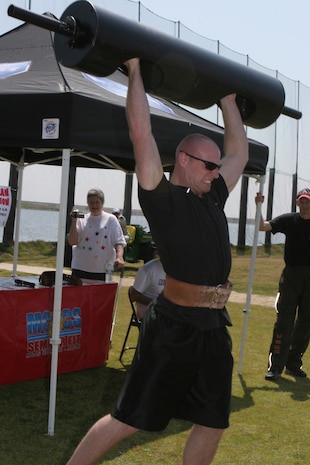 Allen Goode, a contestant in the 191-pound and up weight class, pressed the nearly 200-pound bar during the 3rd Annual Strongman Competition here April 11. Contestants had to press the bar as many times as they could in 60 seconds.