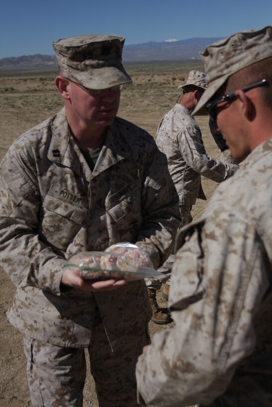 Lt. Randal K. Potter, 2nd Battalion, 3rd Marine Regiment’s battalion chaplain, delivers cookies to Marines and sailors from 2nd Battalion, 4th Marine Regiment, at the Combat Center’s Emerson Lake training area April 12.
