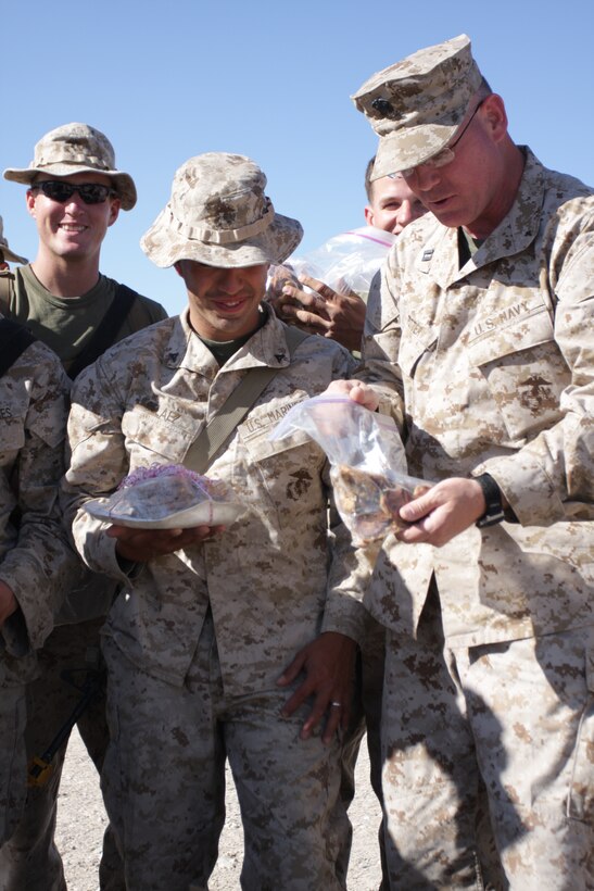 Lt. Randal K. Potter, 2nd Battalion, 3rd Marine Regiment’s battalion chaplain, delivers cookies to Marines and sailors from 2/3 at a forward operating base in Combat Center’s Range 215 April 12.