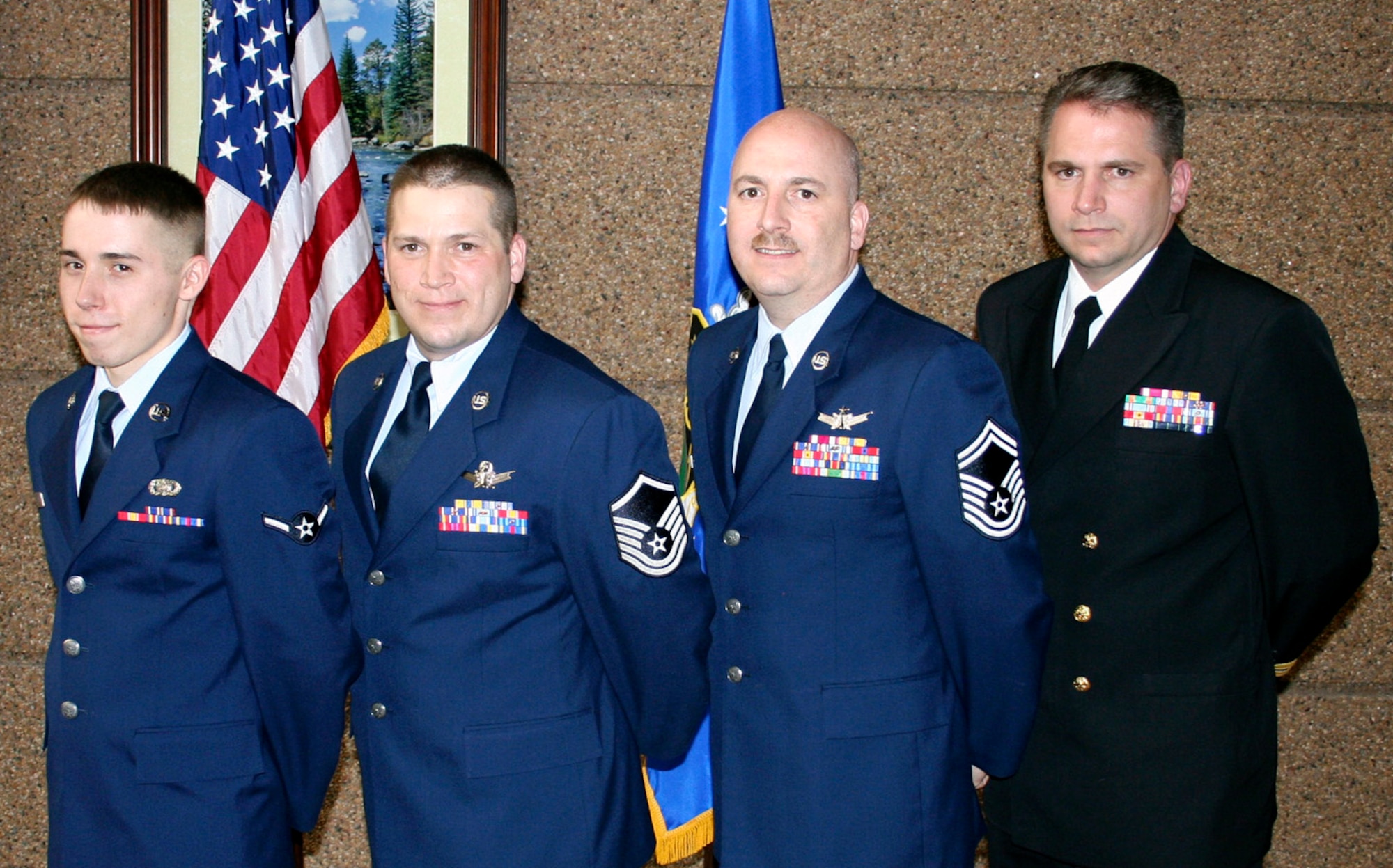 (L to R) Airman Jeremy T. Scott, Master Sgt. Jeffery P. Scott, Senior Master Sgt. Todd M. Scott, and Lt. Sean L. Scott (USN) show their family unity during the promotion ceremony of Master Sgt. Todd Scott March 7 in Colorado Springs. Together, the nephew and brothers have a total of 46 years in U.S. military service. (U.S.Air Force photo/Tech. Sgt. Sack L. Sounakhene)