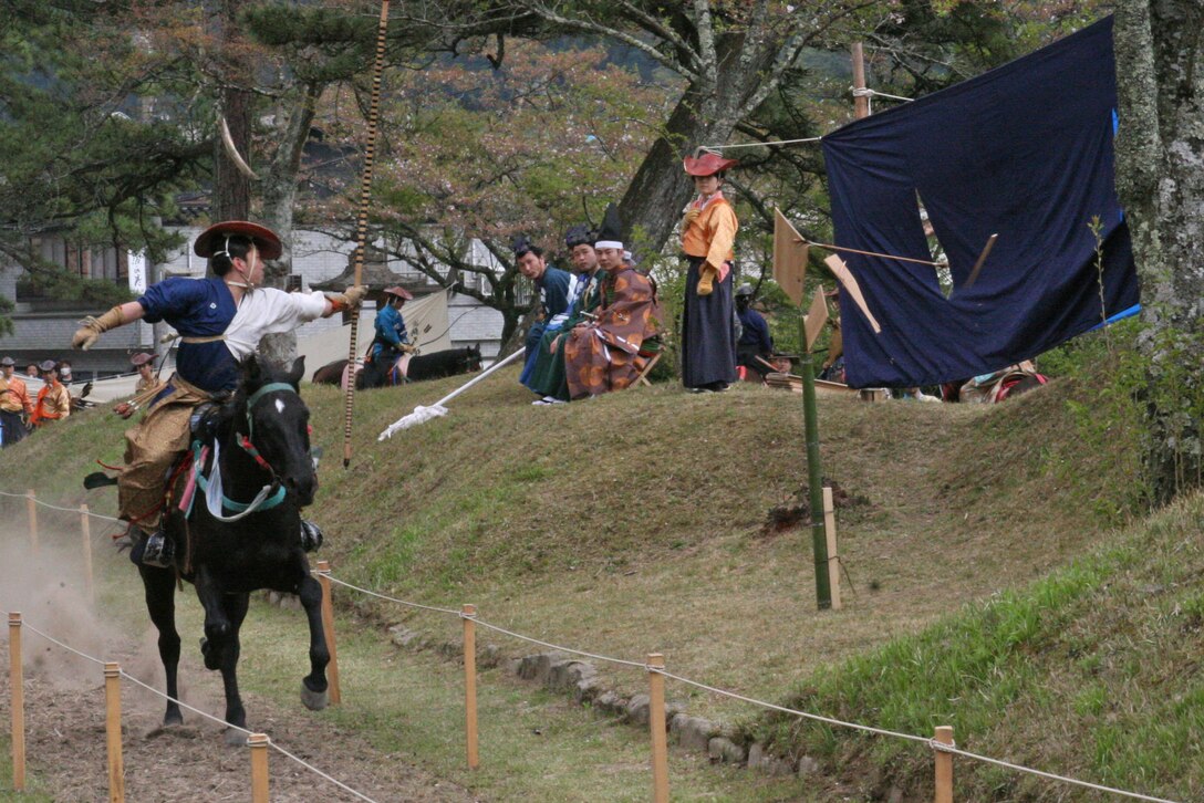 A rider releases an arrow and hits the first target during the Tsuwano Horseback Archery Festival April 12. In the beginning of the Kamakura period (1185-1333), Minamoto no Yoritomo founded the ritual of Japanese horseback archery, Yabusame.