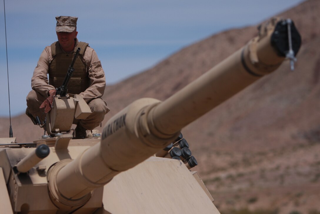 Lance Cpl. Tyler Roberts, a tank driver with Company C, 1st Tank Battalion, inspects weapons on the tank he drives before it is used on the show “Lock and Load,” hosted by retired Gunnery Sgt. R. Lee Ermey on the History Channel April 13.