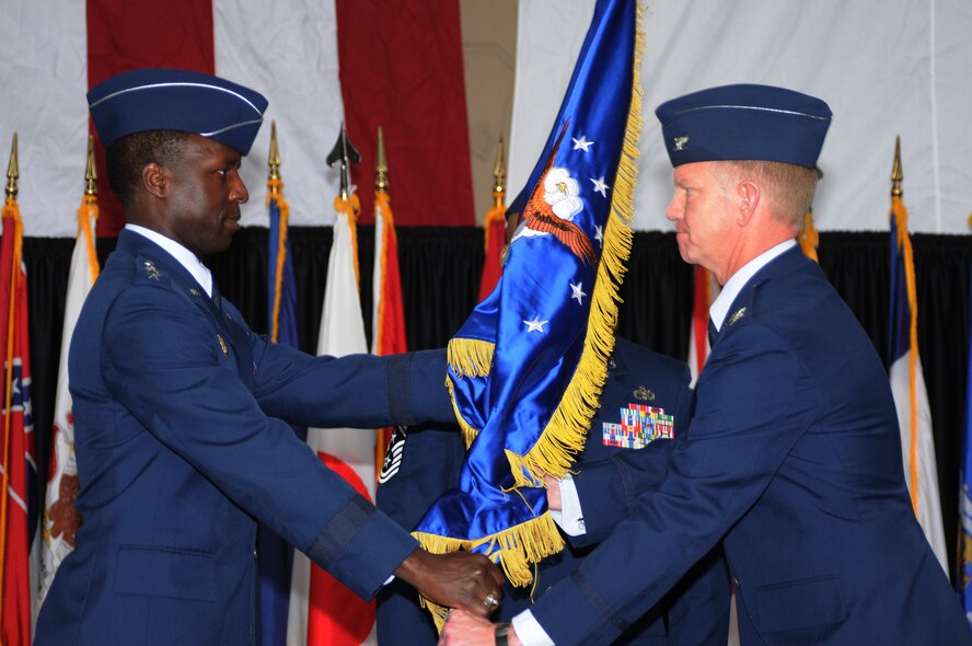 YOKOTA AIR BASE, Japan -- Lt. Gen. Edward A. Rice Jr. (left), commander of U.S. Forces Japan and 5th Air Force, presents the 374th Airlift Wing guidon to the wing's newest commander, Col. J. Marcus Hicks, during a change of command ceremony April 14. (U.S Air Force photo/Tech. Sgt. Kimberly Spinner) 