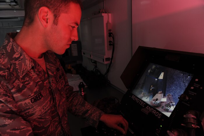 Airman 1st Class Derrin Creek, an explosive ordnance disposal (EOD) journeymen with the 151st Civil Engineer Squadron, removes a suspicious package using a camera mounted on the F6A robot, April 9, Nellis Air Force Base, Nev. EOD uses its' first line defender to neutralize potential threats to Air Force assets and personnel state side and abroad. (U.S. Air Force photo by Senior Airman Nadine Y. Barclay/RELEASED)