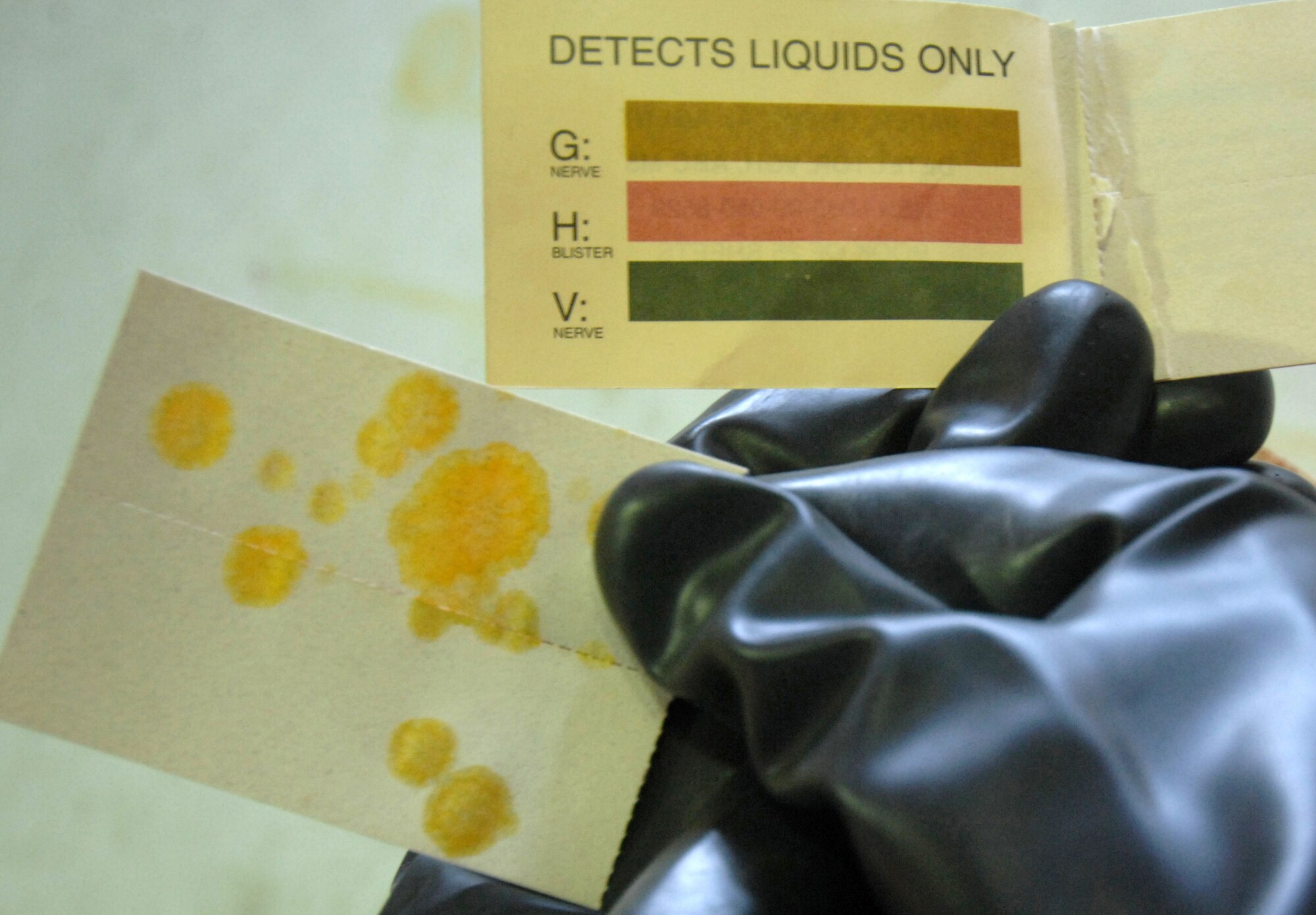 EIELSON AIR FORCE BASE, ALASKA -- Senior Airman John Buckley demonstrates how to identify chemical agents on a piece of M8 paper Apr. 7. Airman Buckley is a chemical, biological, radiological, nuclear, and high-yield explosives training instructor and responder assigned to the 354th Civil Engineering Squadron. (U.S. Air Force photo/Senior Airman Christopher Boitz)