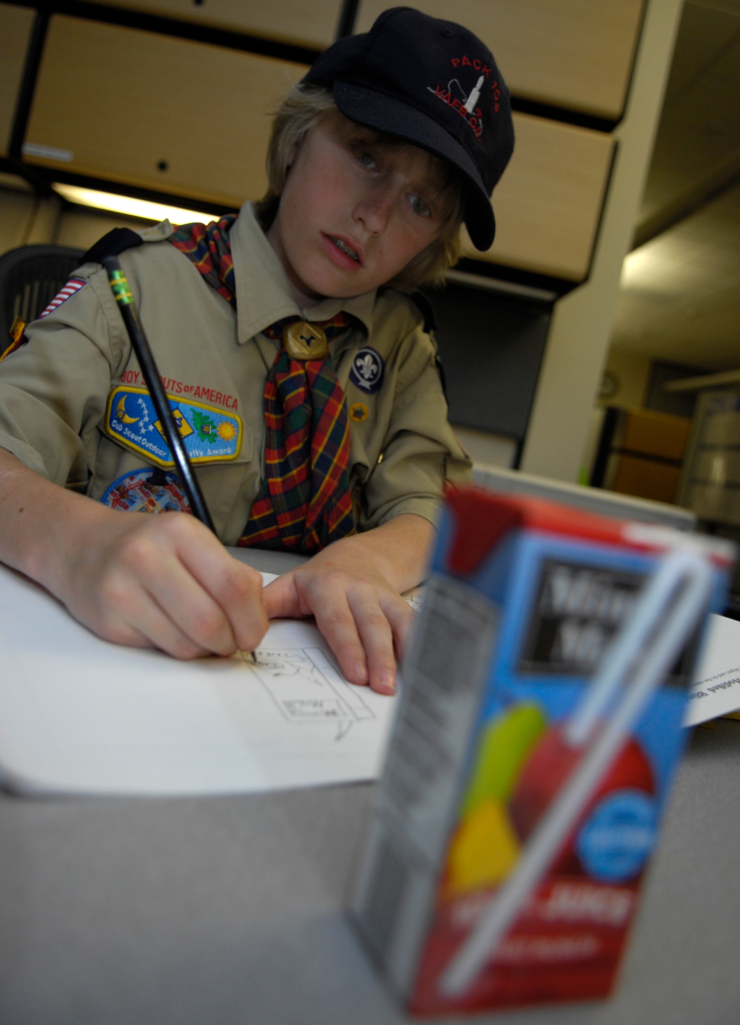 VANDENBERG AIR FORCE BASE, Calif. --  Ethan Ramey, a Vandenberg Cub Scout, sketches his apple juice box April 9 in an attempt to get one step closer to his Art Merit Badge. One of the requirements to obtain the badge is speaking with a professional artist, who in this case was Jan Kays, a 30th Space Wing Public Affairs graphic illustrator. (U.S. Air Force photo/Airman 1st Class Andrew Lee)