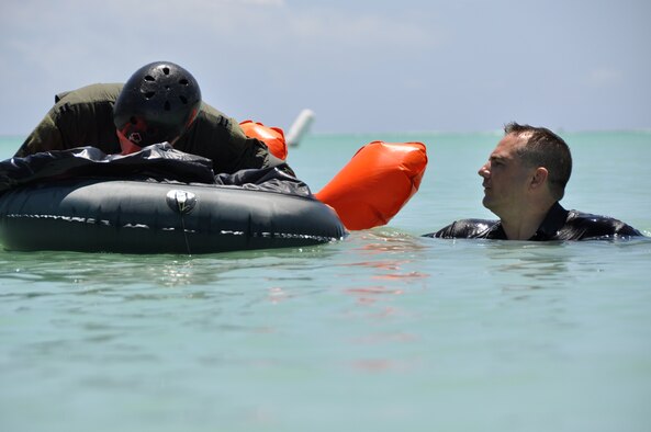 Tech. Sgt. Sherwood Brown, 15th Operational Support Squadron SERE instructor, prepares members of the Hickam Air Force Base, Hawaii, flying community for refresher water survival training April 6. (U.S. Air Force photo/Tech Sgt. Cohen A. Young) 