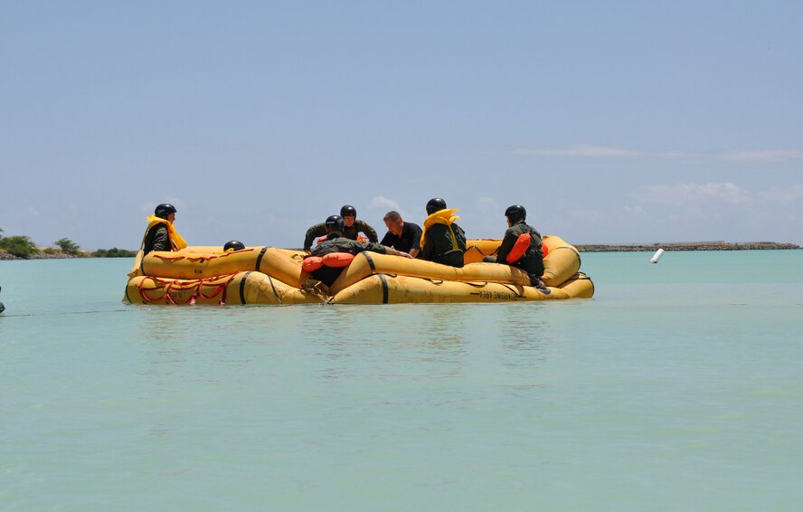HICKAM AFB  -  U.S. Air Force Survival Evasion Resistance Escape Specialist Tech. Sgt. Sherwood Brown and aircrew members talk about the "Five A's" during refresher water survival training on April 6, 2009 while in the waters adjacent to Hickam AFB, Hawaii . (U.S.  Air Force photo/Tech Sgt. Cohen A. Young) 