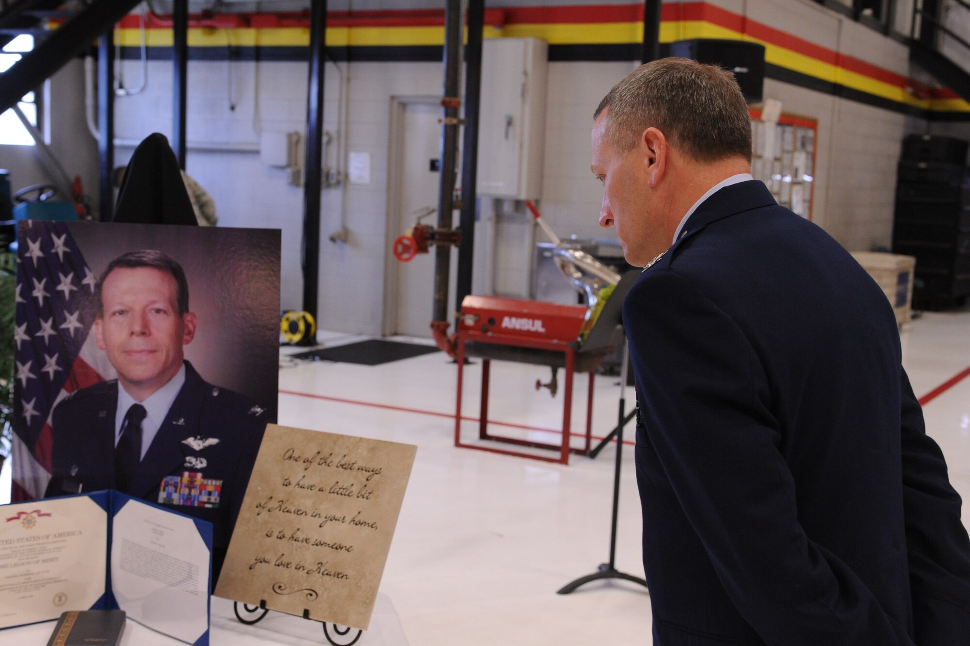 Col. Walter J. Sams, 419th Fighter Wing commander, takes a moment to honor the memory of Col. Stephen E. Mittuch, 419th Maintenance Group commander. Colonel Sams spoke at a memorial service for Col. Mittuch Apr. 10. (U.S. Air Force photo/Staff Sgt. Kyle Brasier)