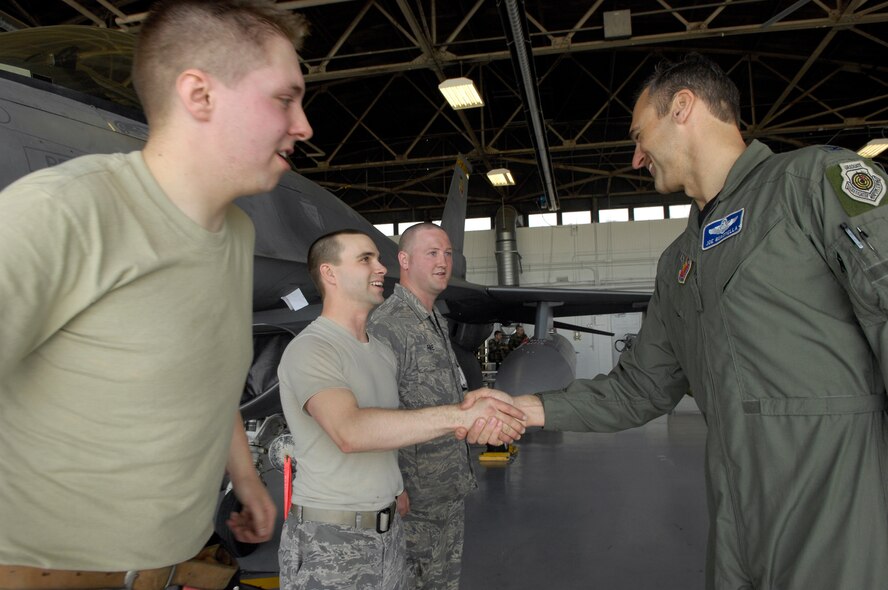 Col. Joseph Guastella, commander of the 20th Fighter Wing, congratulates members of the 79th Air Maintenance Unit at the end of the Weapons Load Crew of the Quarter Competition at Shaw AFB, S.C., April 10, 2009. Load crews are evaluated on safety and reliability as well as a toolbox inspection and written exam.  (U.S. Air Force photo by Senior Airman Kathrine McDowell/Released)