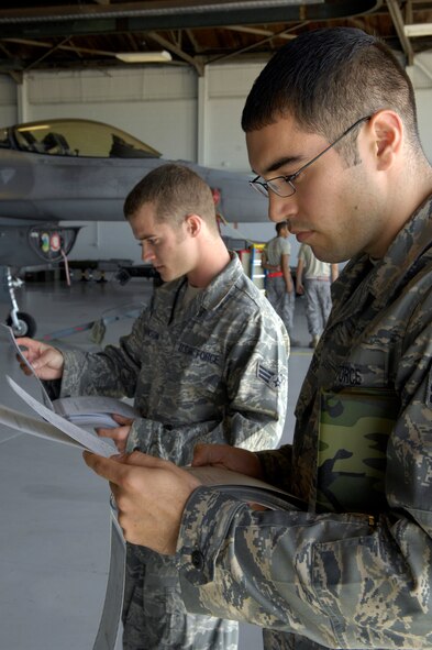 Staff Sgt. Gerald Ratulowski, right, and Senior Airman Zachary Johnson, both members of the 20th Maintenance Group, review their evaluation sheets at the end of the Weapons Load Crew of the Quarter Competition at Shaw AFB, S.C., April 10, 2009. Load crews are evaluated on safety and reliability as well as a toolbox inspection and written exam.  (U.S. Air Force photo by Senior Airman Kathrine McDowell/Released)